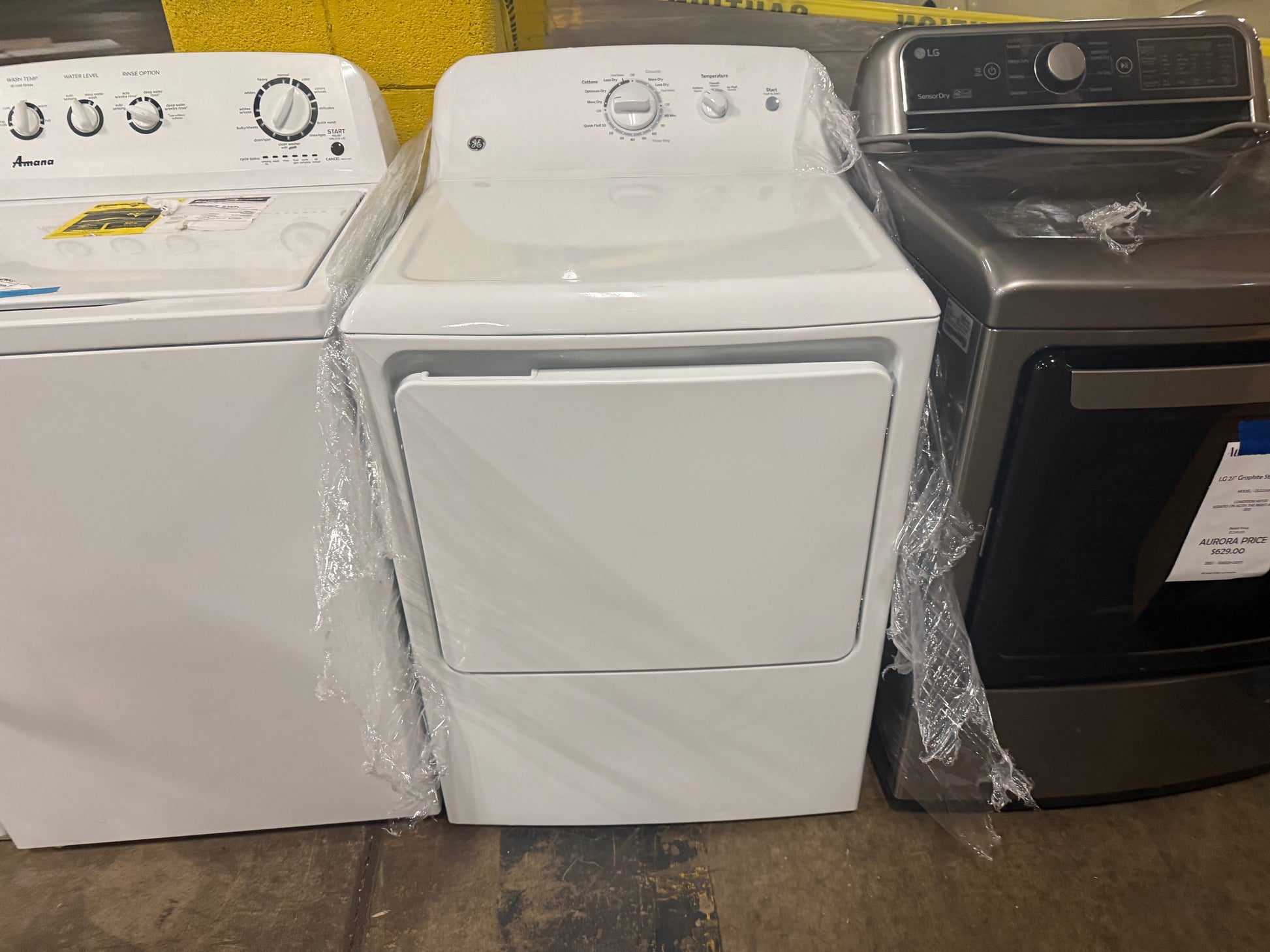 Front close up view of the open white reversible door and aluminized alloy steel drum of the GE GTX22GASKWW laundry dryer