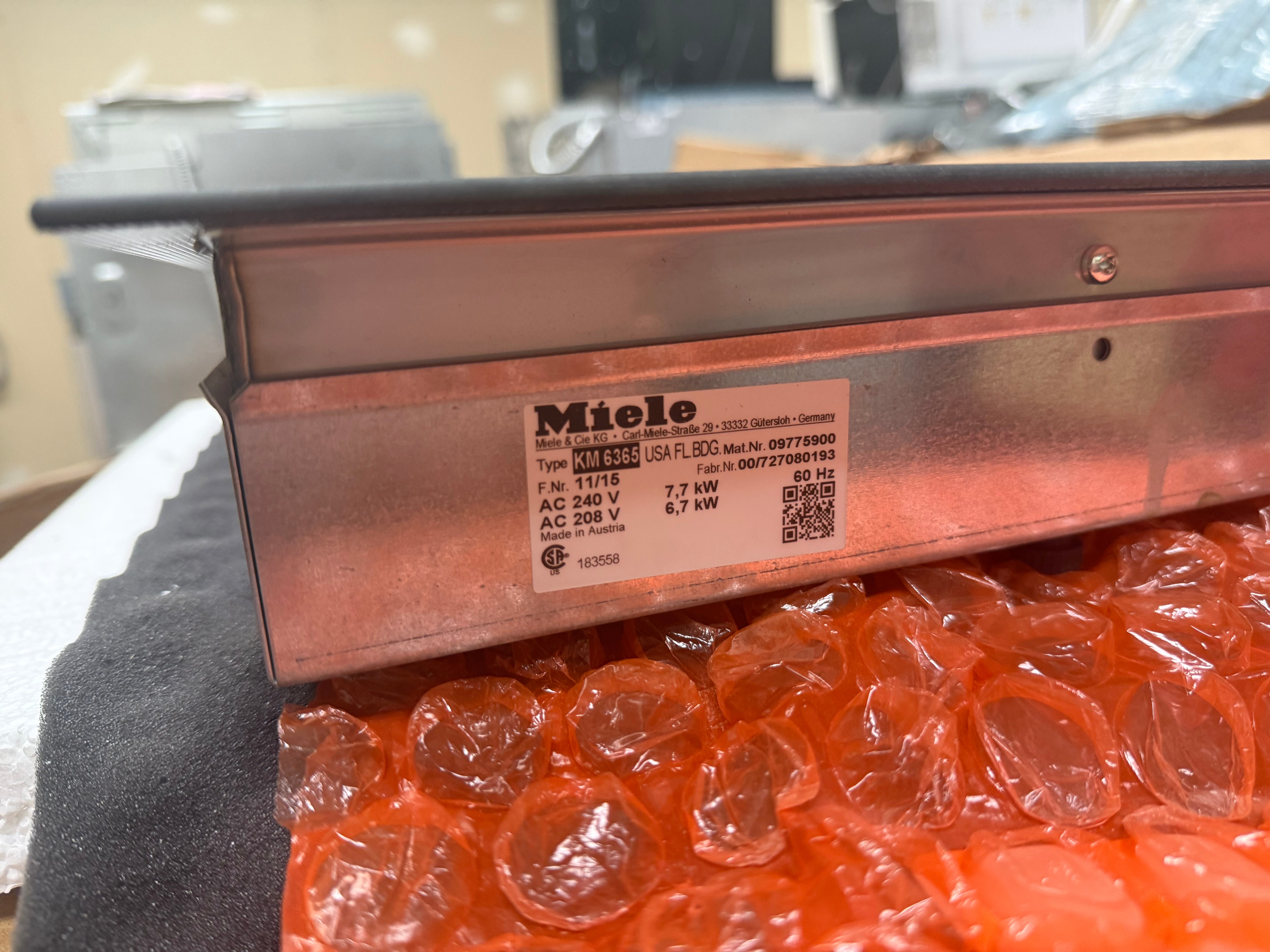 Close up of DirectSelection touch controls and PowerFlex zone markings on the Miele KM 6365 induction cooktop
