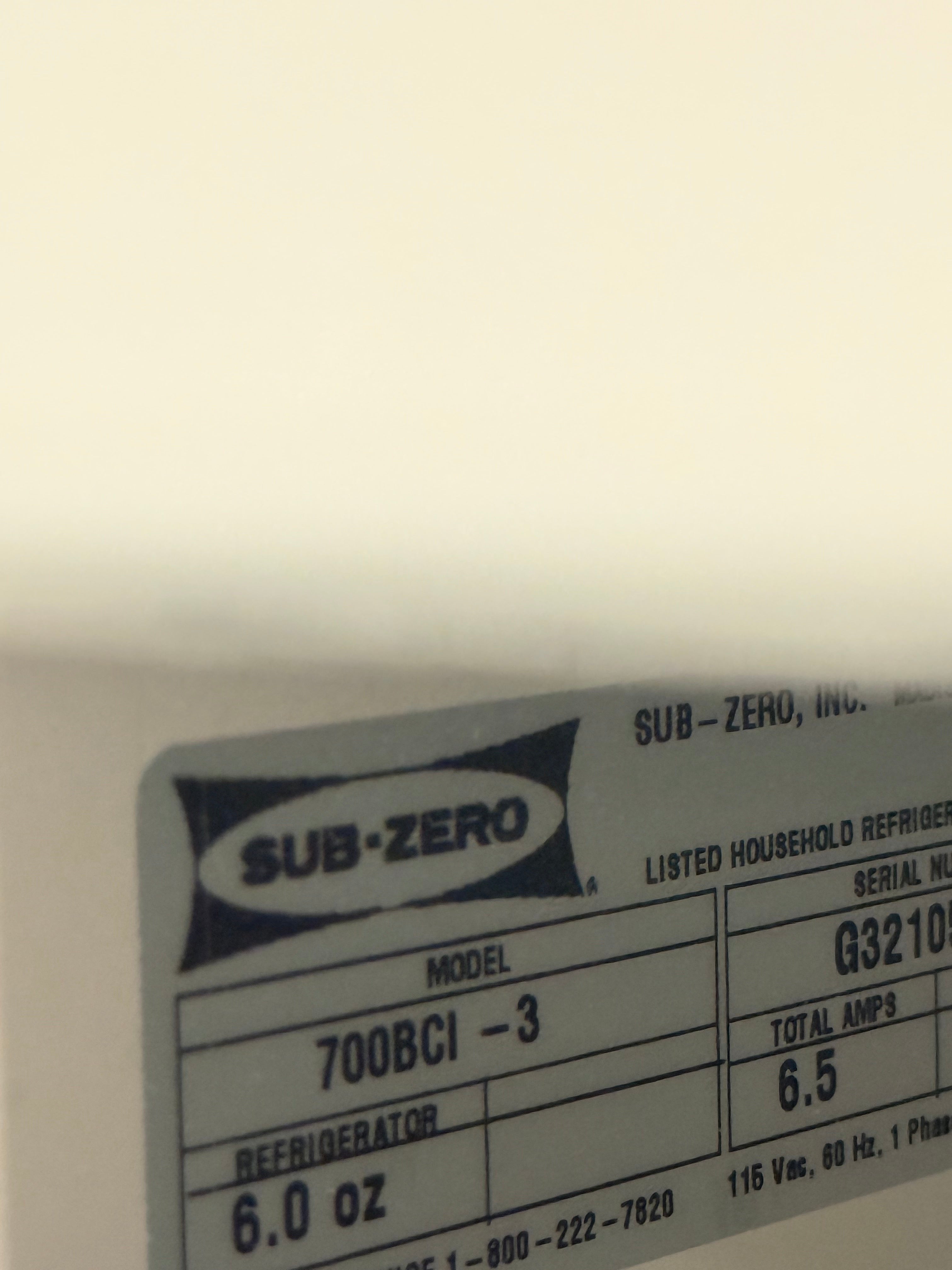 A close-up of a Sub-Zero refrigerator label showing the model 700BCI-3, with visible text including SUB-ZERO, LISTED HOUSEHOLD REFRIGERATOR, SERIAL NUMBER, REFRIGERATOR, 6.0 oz, and 6.