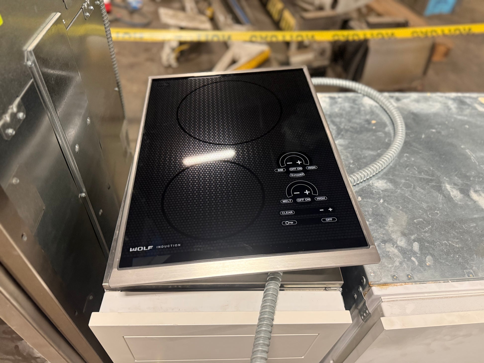 Sub Zero Wolf 15 inch transitional induction cooktop in black glass with stainless steel trim