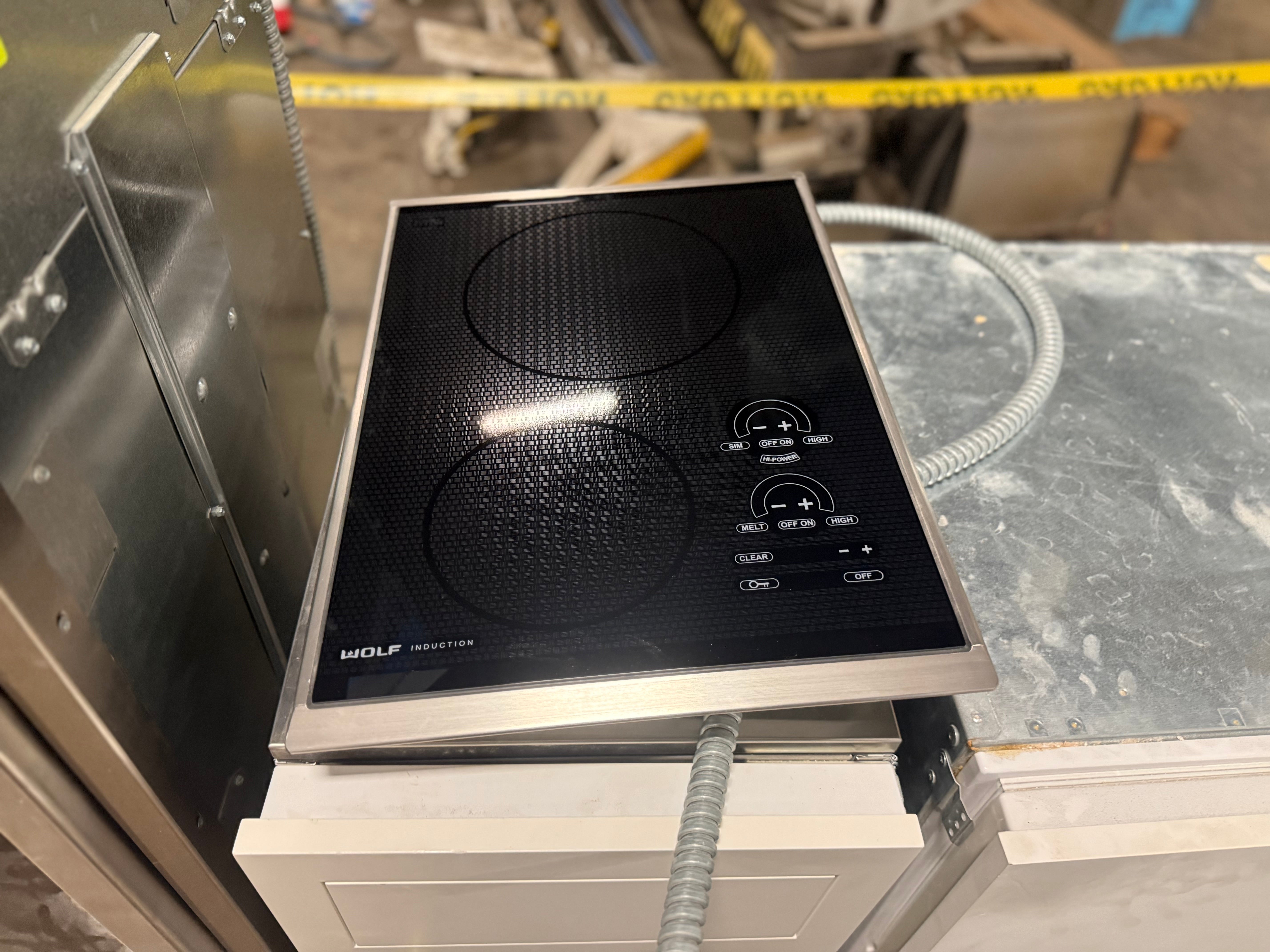 Sub Zero Wolf 15 inch transitional induction cooktop in black glass with stainless steel trim