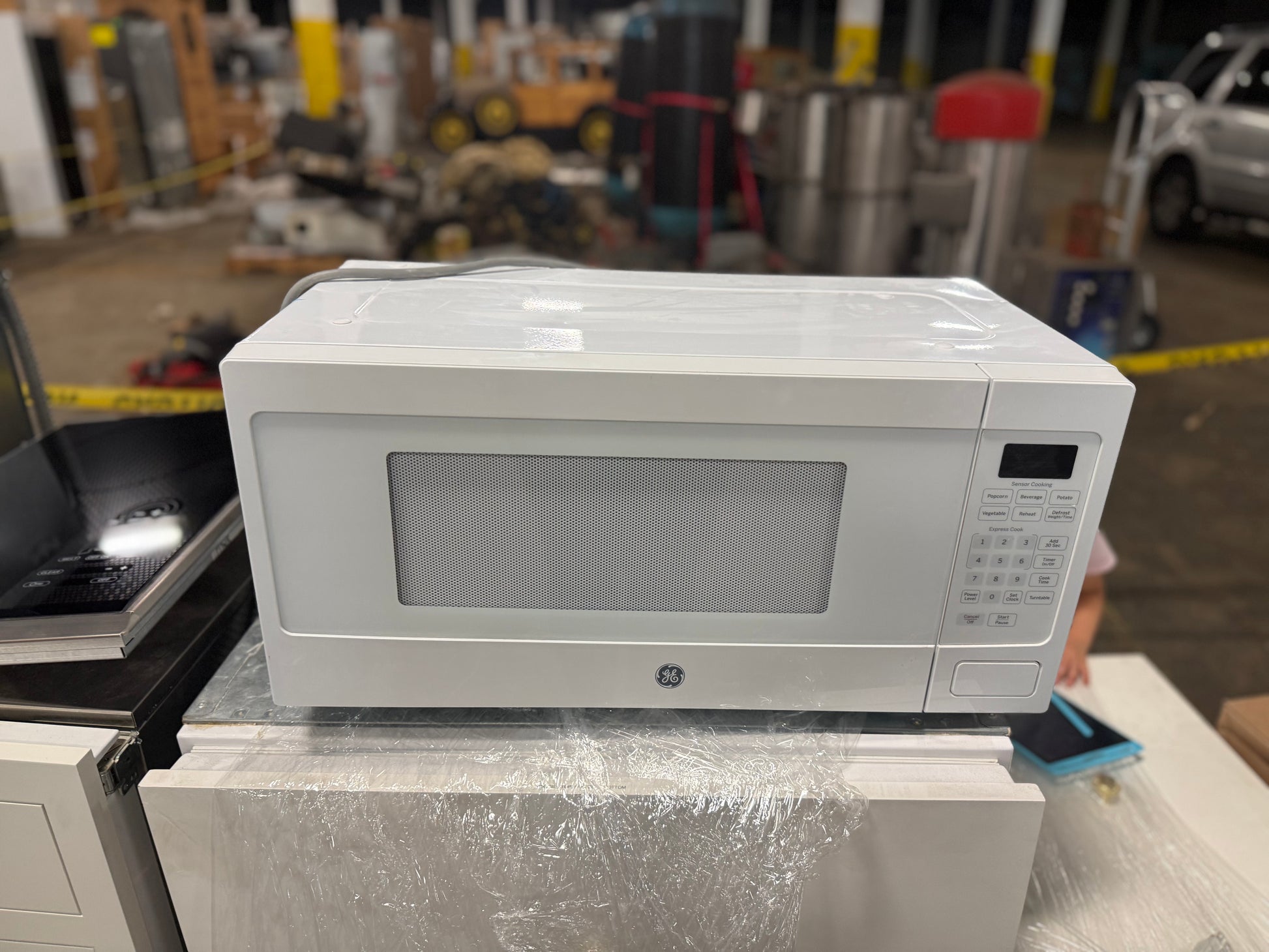 Close up view of the touch control panel and digital display on the white GE Profile microwave