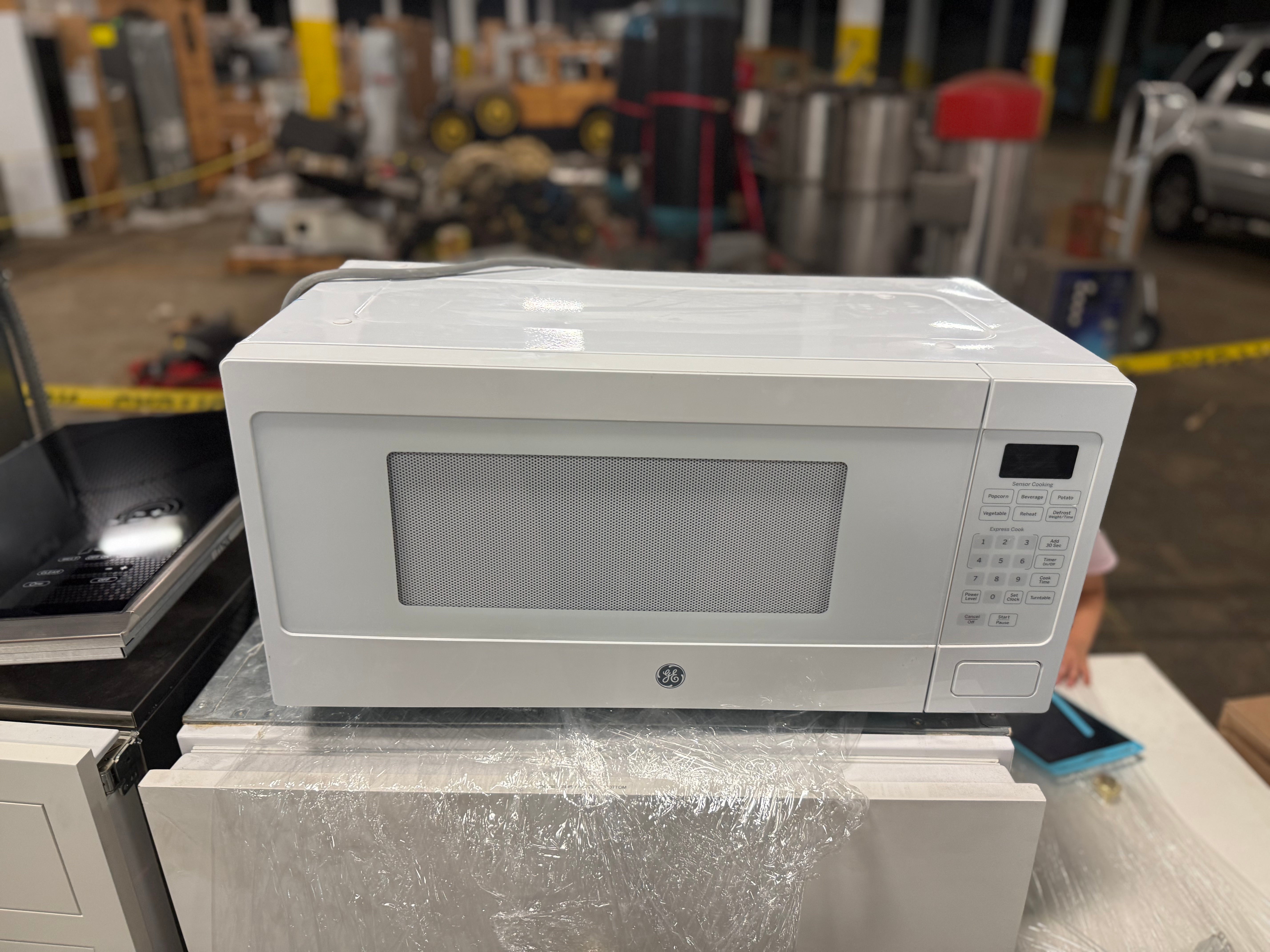 Close up view of the touch control panel and digital display on the white GE Profile microwave