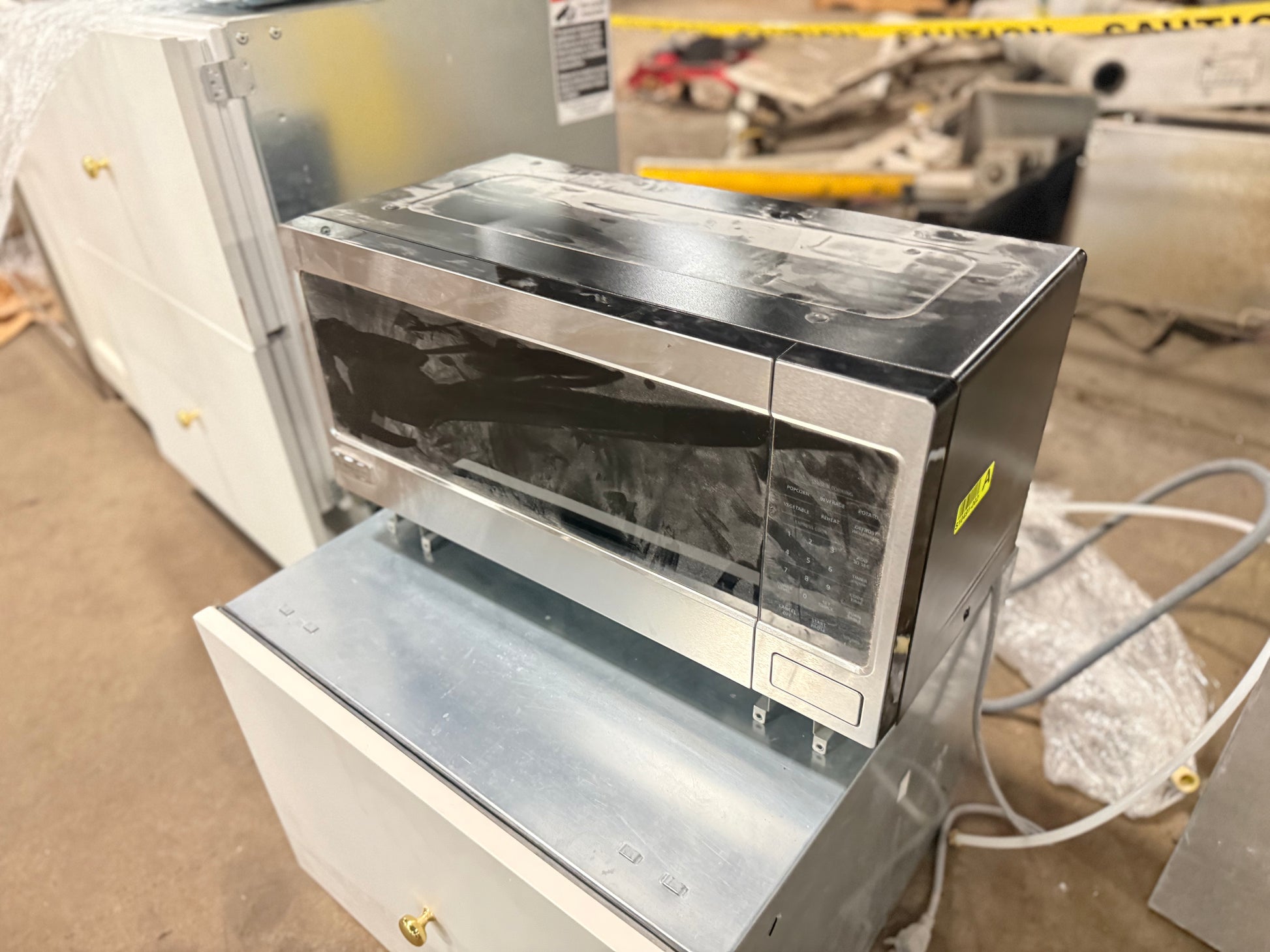 Close up view of the touch control panel and display on the Monogram stainless steel microwave