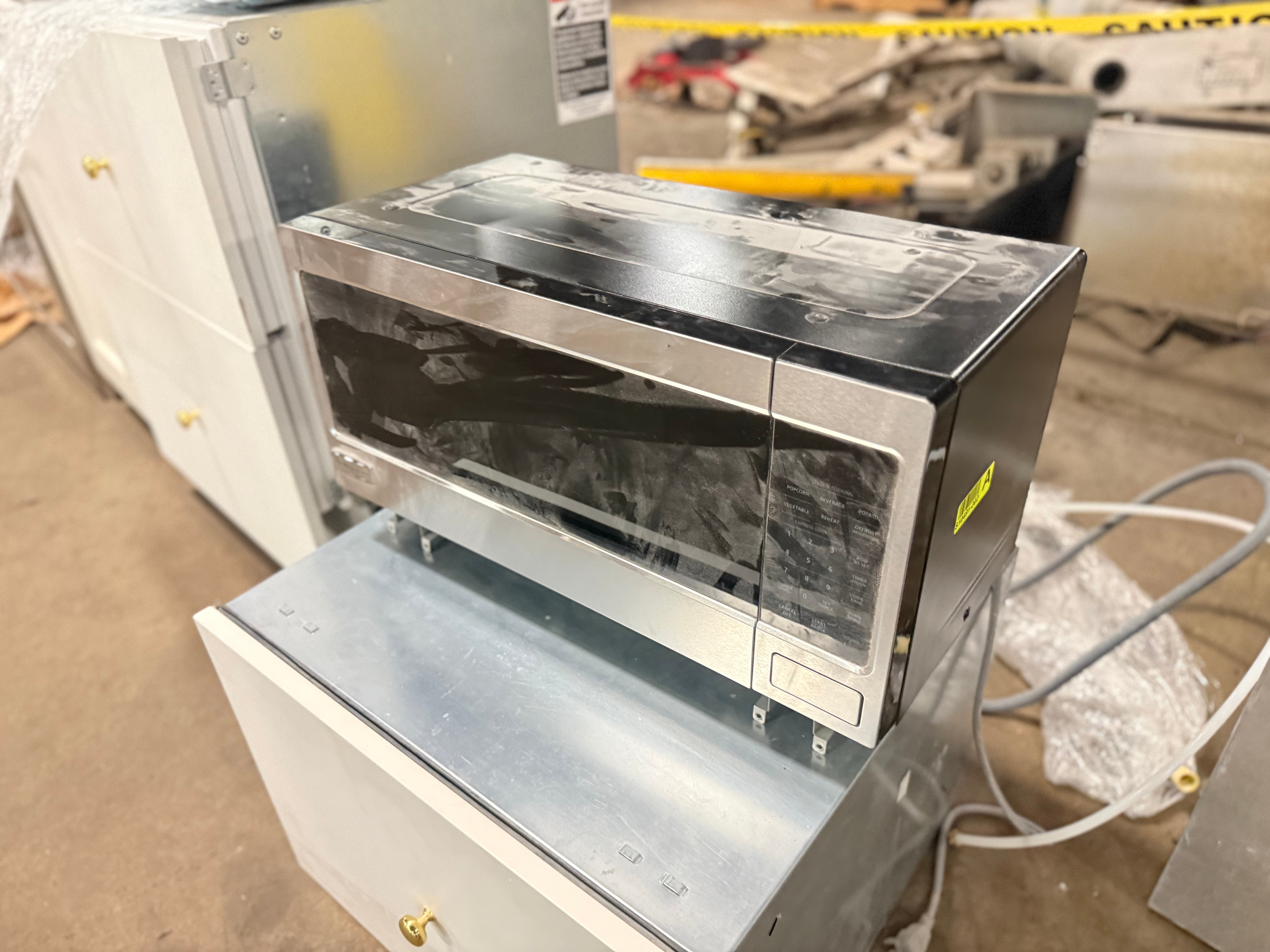 Close up view of the touch control panel and display on the Monogram stainless steel microwave
