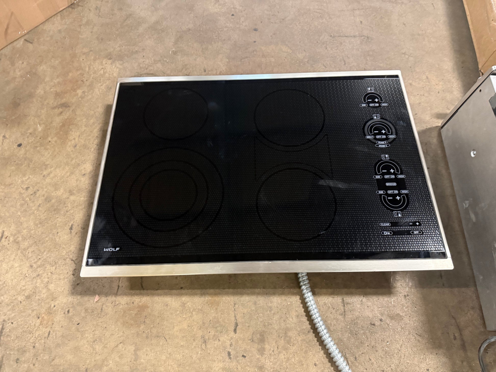 Sub Zero Wolf 30 inch framed electric cooktop in black glass with stainless steel trim CT30ES