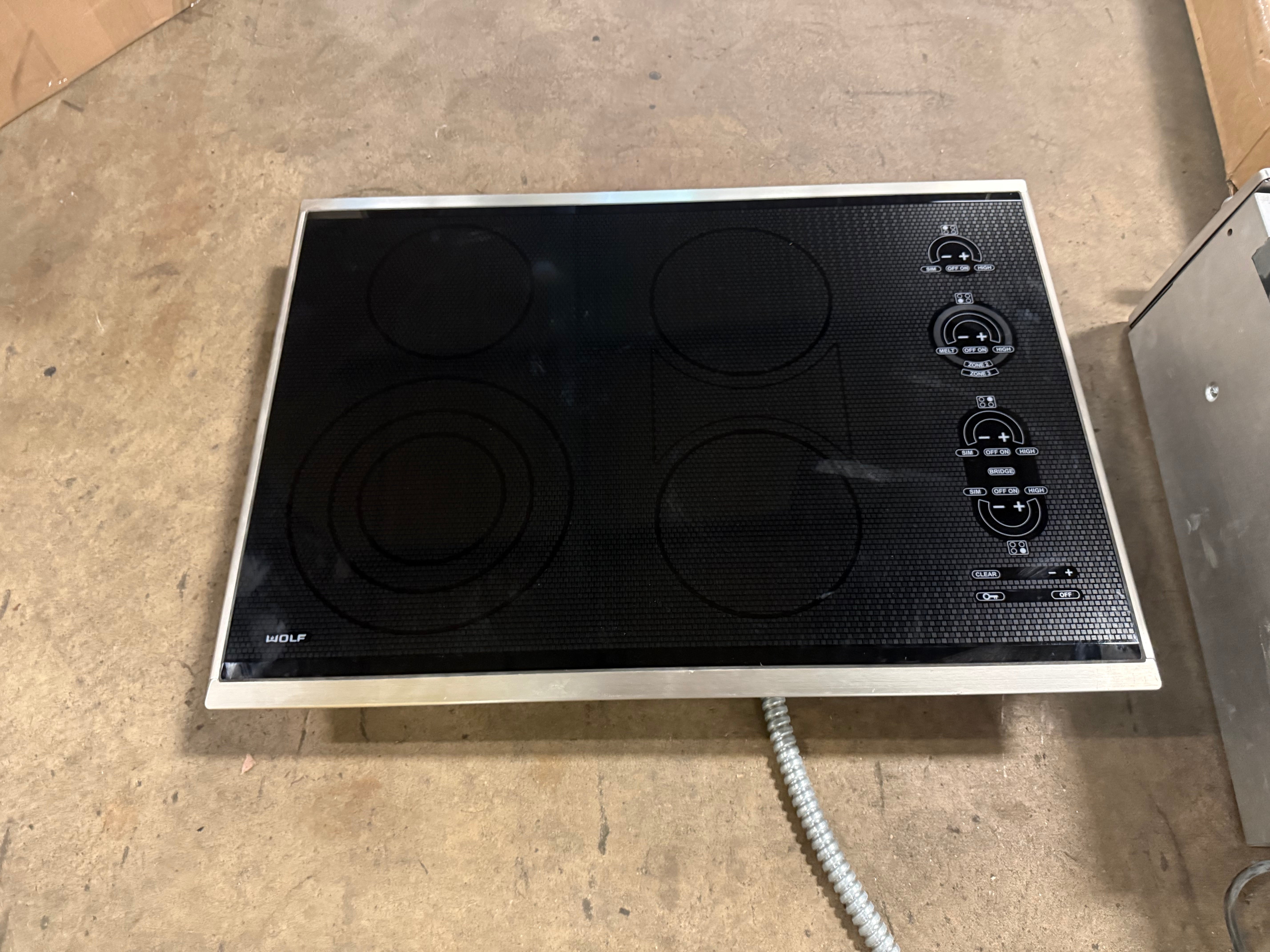 Sub Zero Wolf 30 inch framed electric cooktop in black glass with stainless steel trim CT30ES