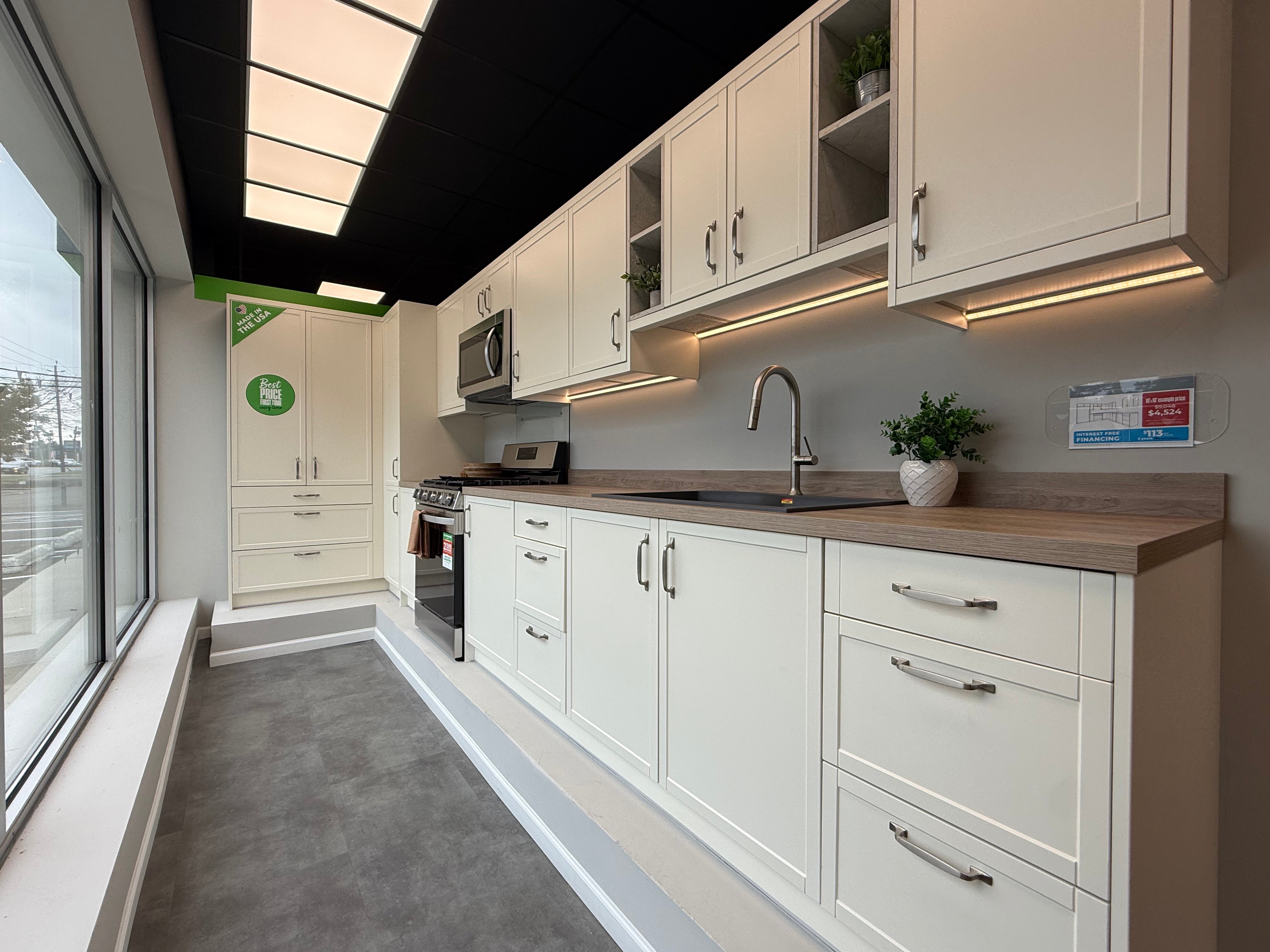 Pre-owned luxury kitchen with premium white cabinetry, countertops and high-end appliances from Aurora Circ
