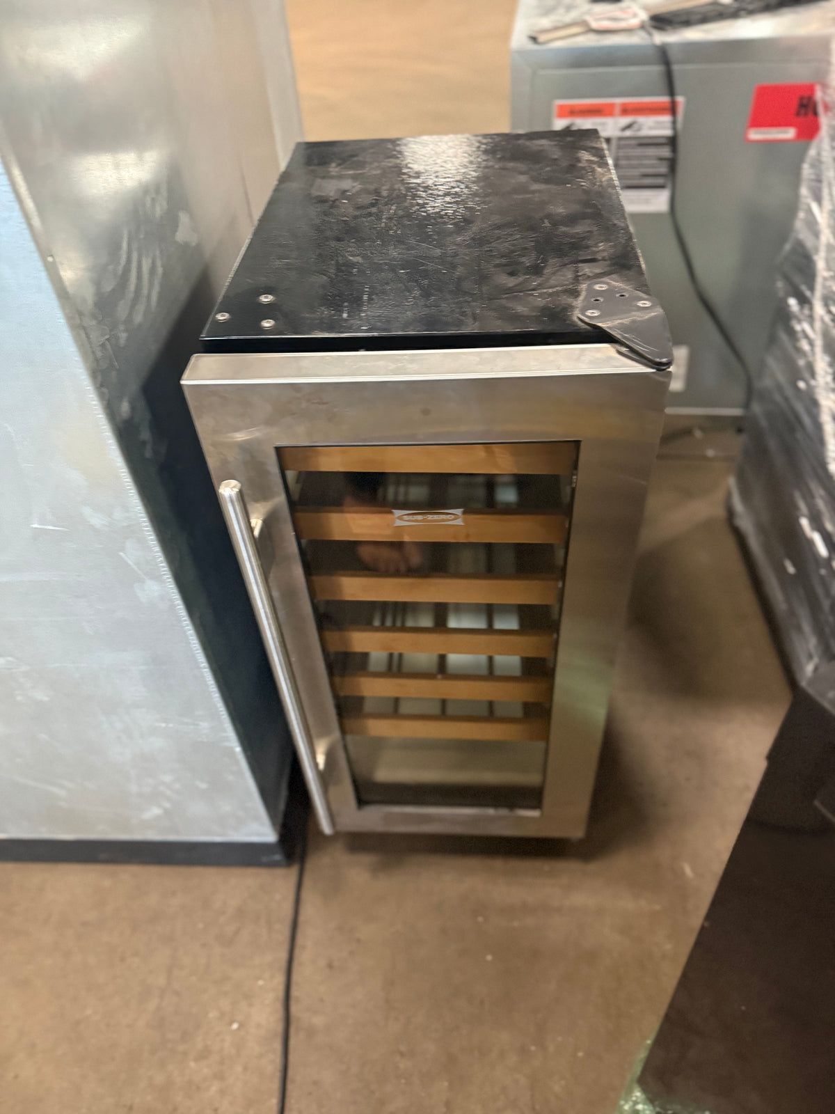 Luxury undercounter wine cooler with glass door and cherry wood trim shelves