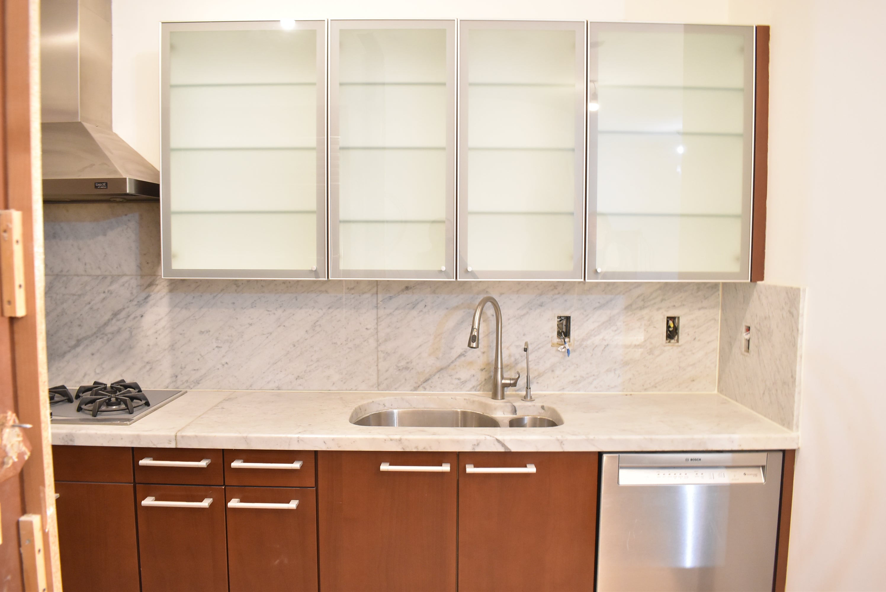 Poggenpohl Brown Toned Transitional Kitchen with Marble Countertops and Appliances