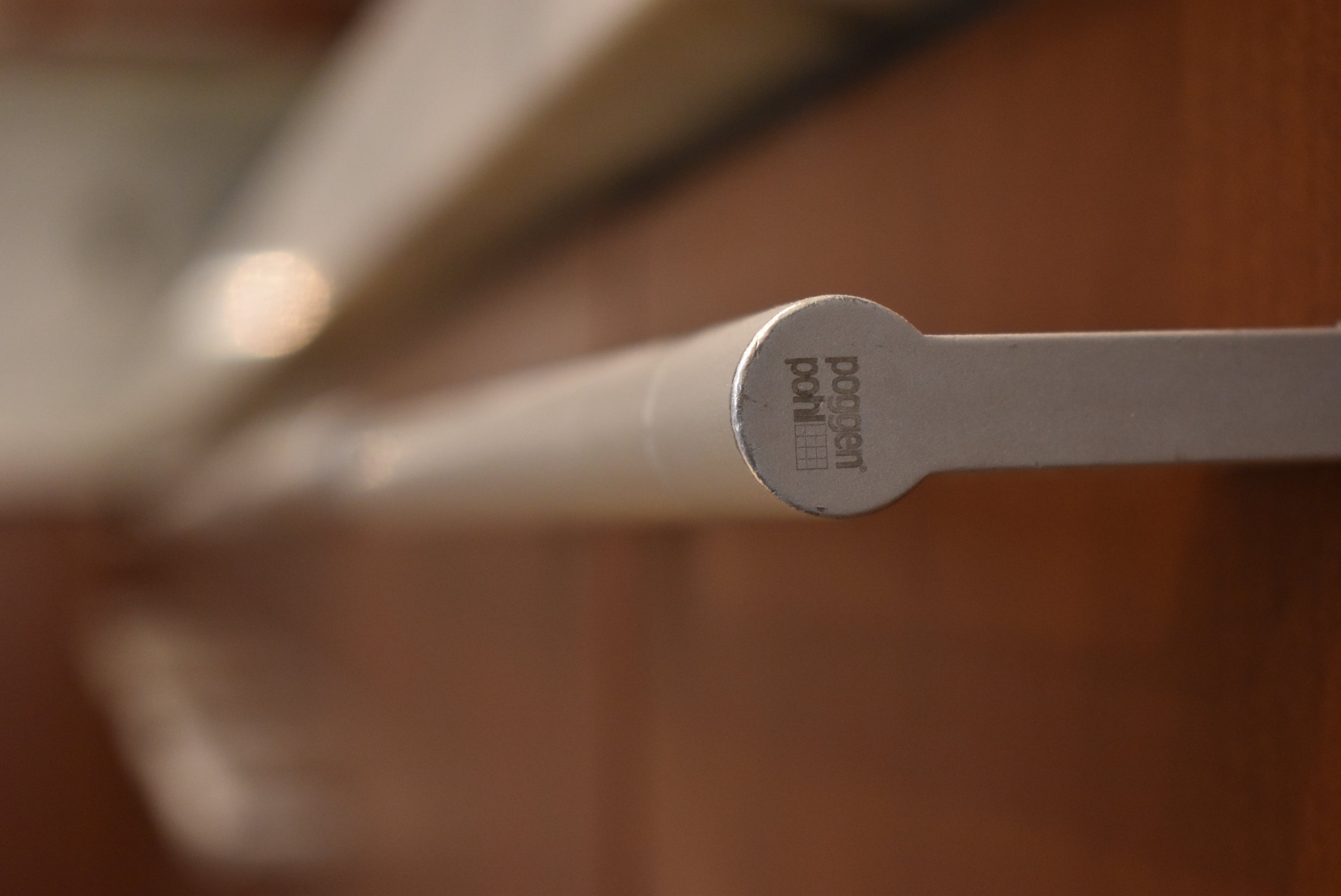 Poggenpohl Brown Toned Transitional Kitchen with Marble Countertops and Appliances