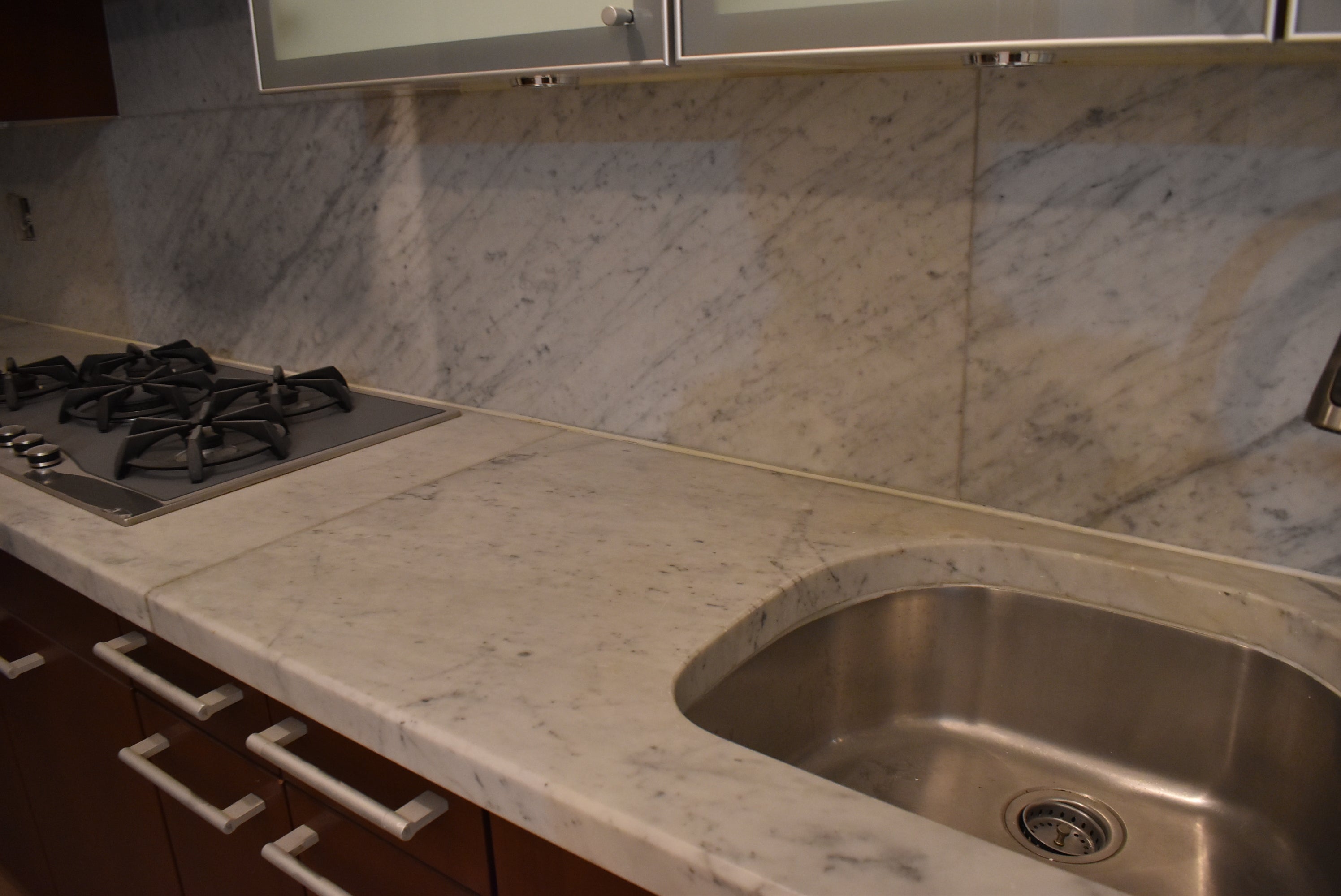 Poggenpohl Brown Toned Transitional Kitchen with Marble Countertops and Appliances