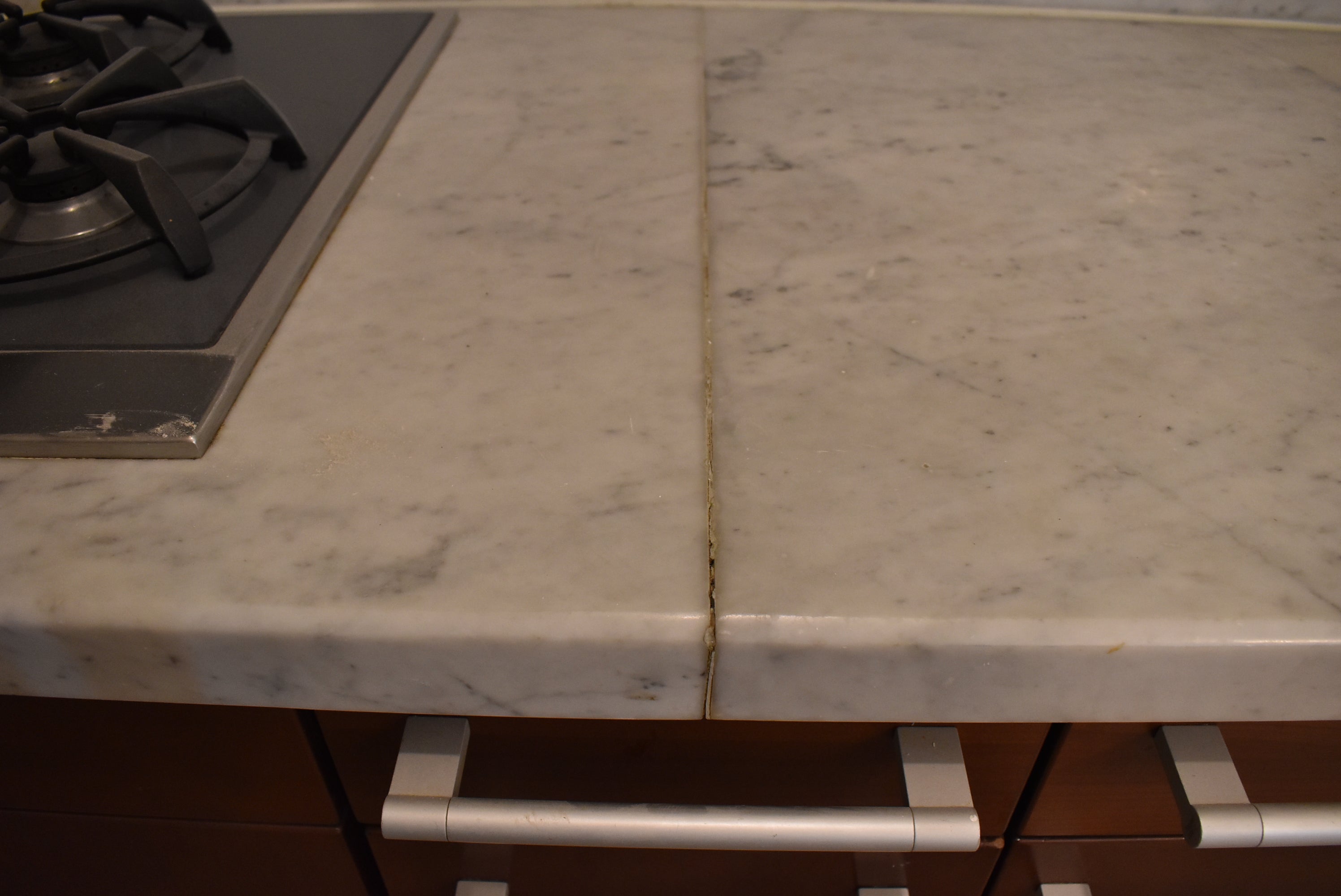 Poggenpohl Brown Toned Transitional Kitchen with Marble Countertops and Appliances