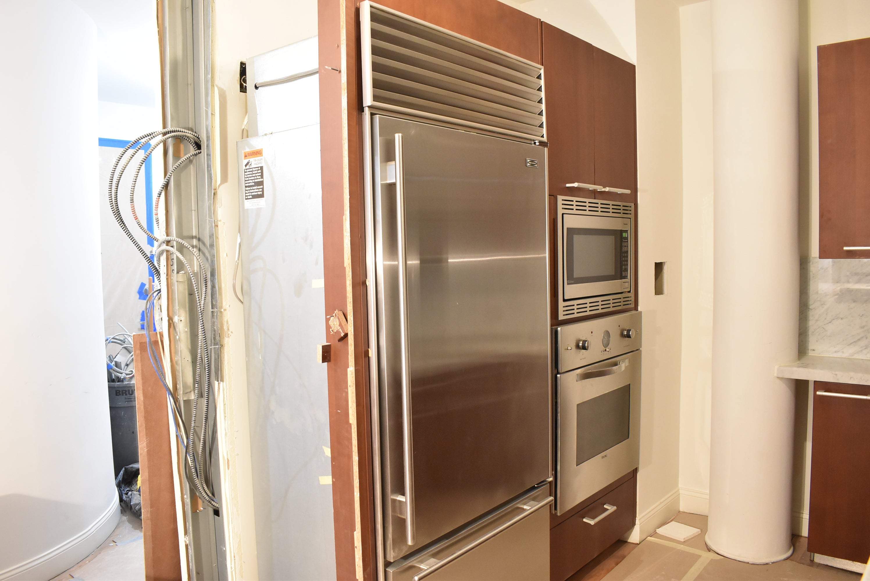 Poggenpohl Brown Toned Transitional Kitchen with Marble Countertops and Appliances