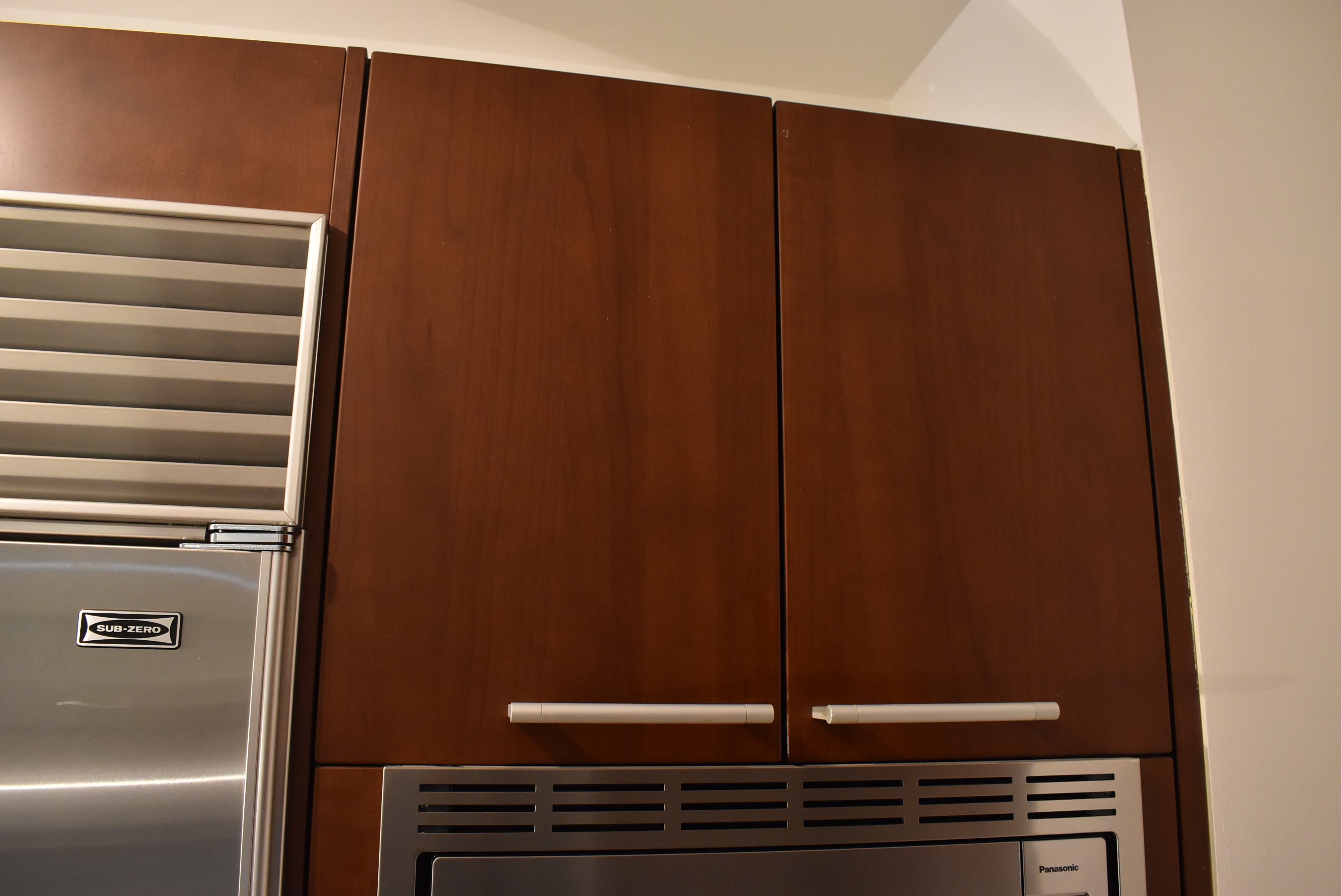 Poggenpohl Brown Toned Transitional Kitchen with Marble Countertops and Appliances