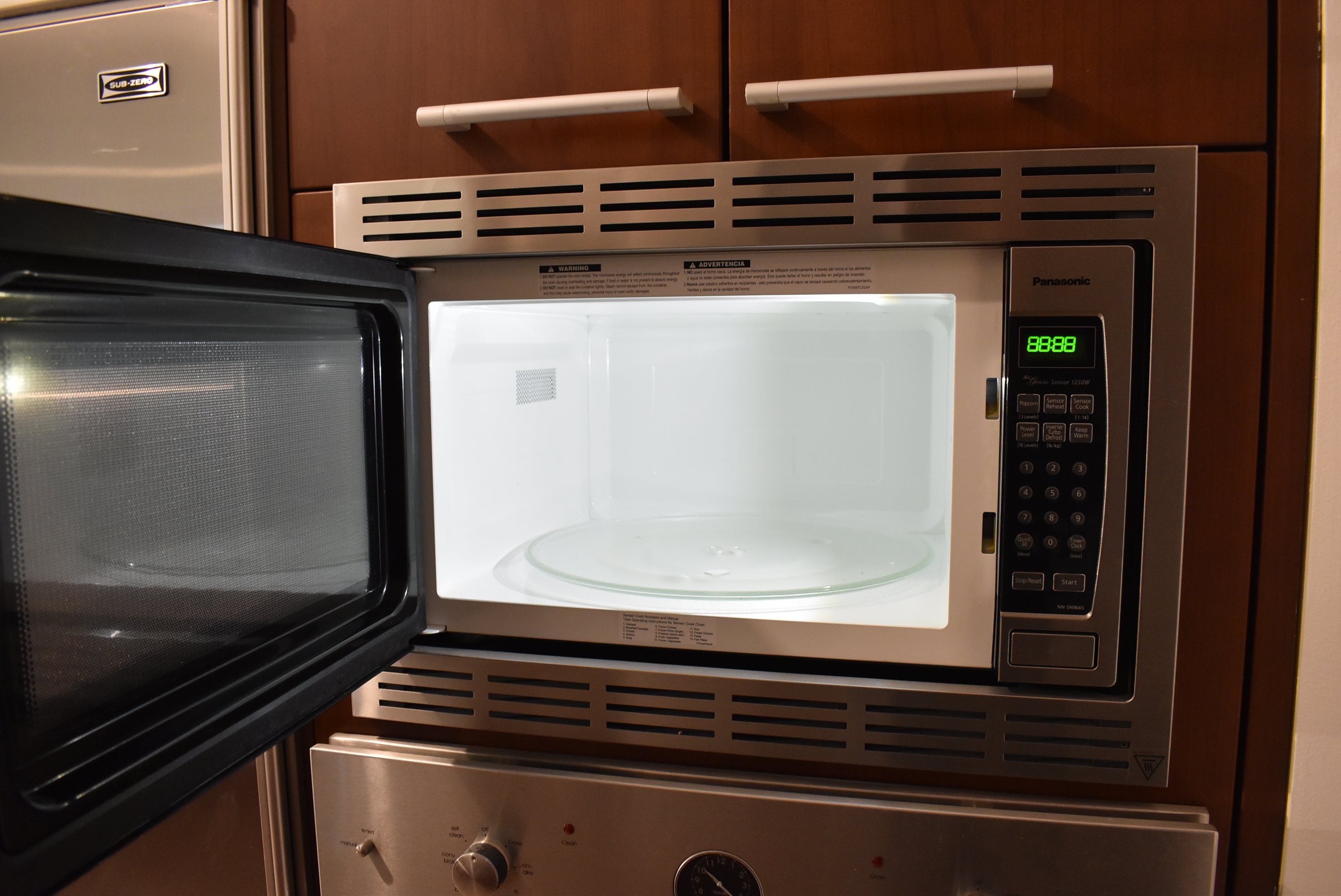 Poggenpohl Brown Toned Transitional Kitchen with Marble Countertops and Appliances