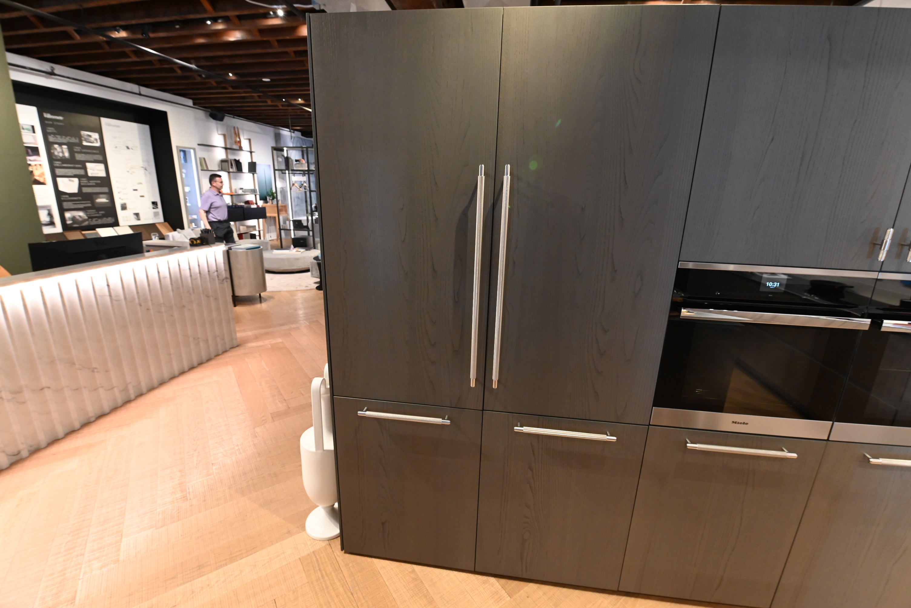 Luxury open-concept home interior showing a premium Copatlife Italian kitchen with a large island facing a bright living space