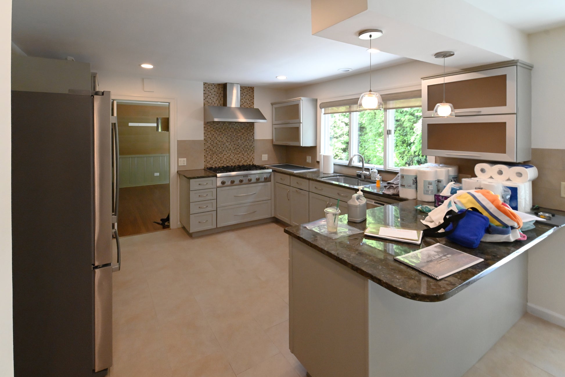 Thomasville blue gray transitional kitchen cabinetry with luxury stainless steel appliances and central island peninsula