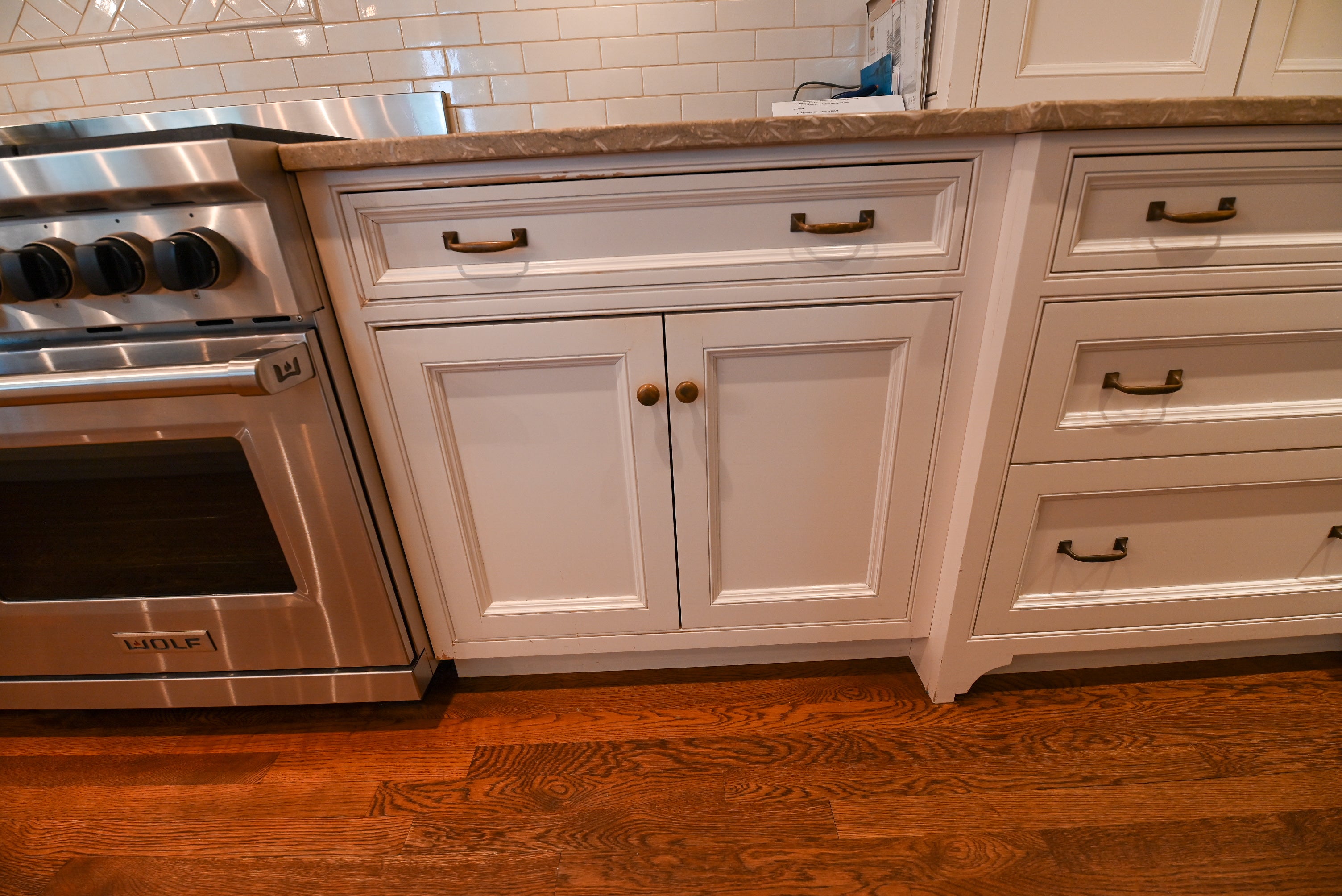 "The Montclair" Transitional White Kitchen with Island & Wolf 48" Range