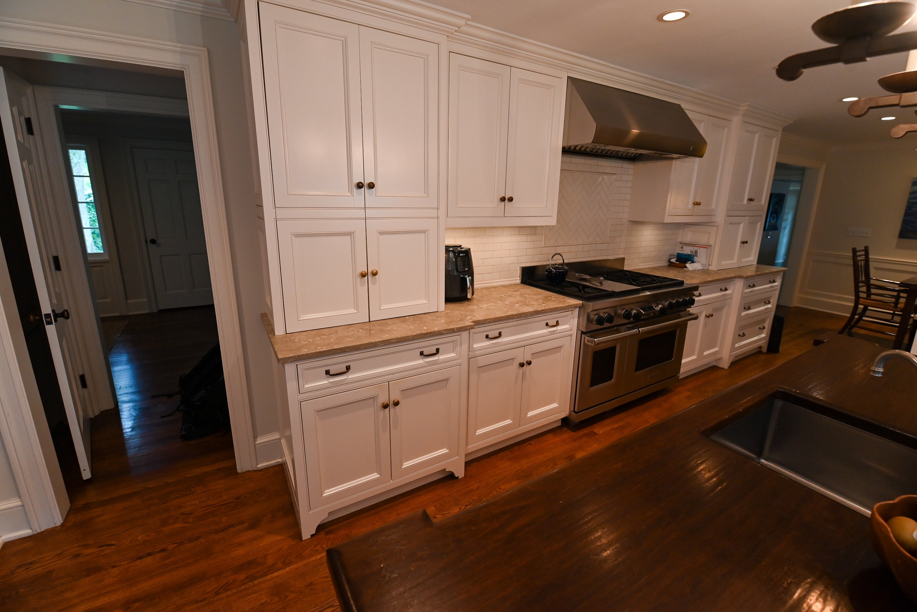 "The Montclair" Transitional White Kitchen with Island & Wolf 48" Range