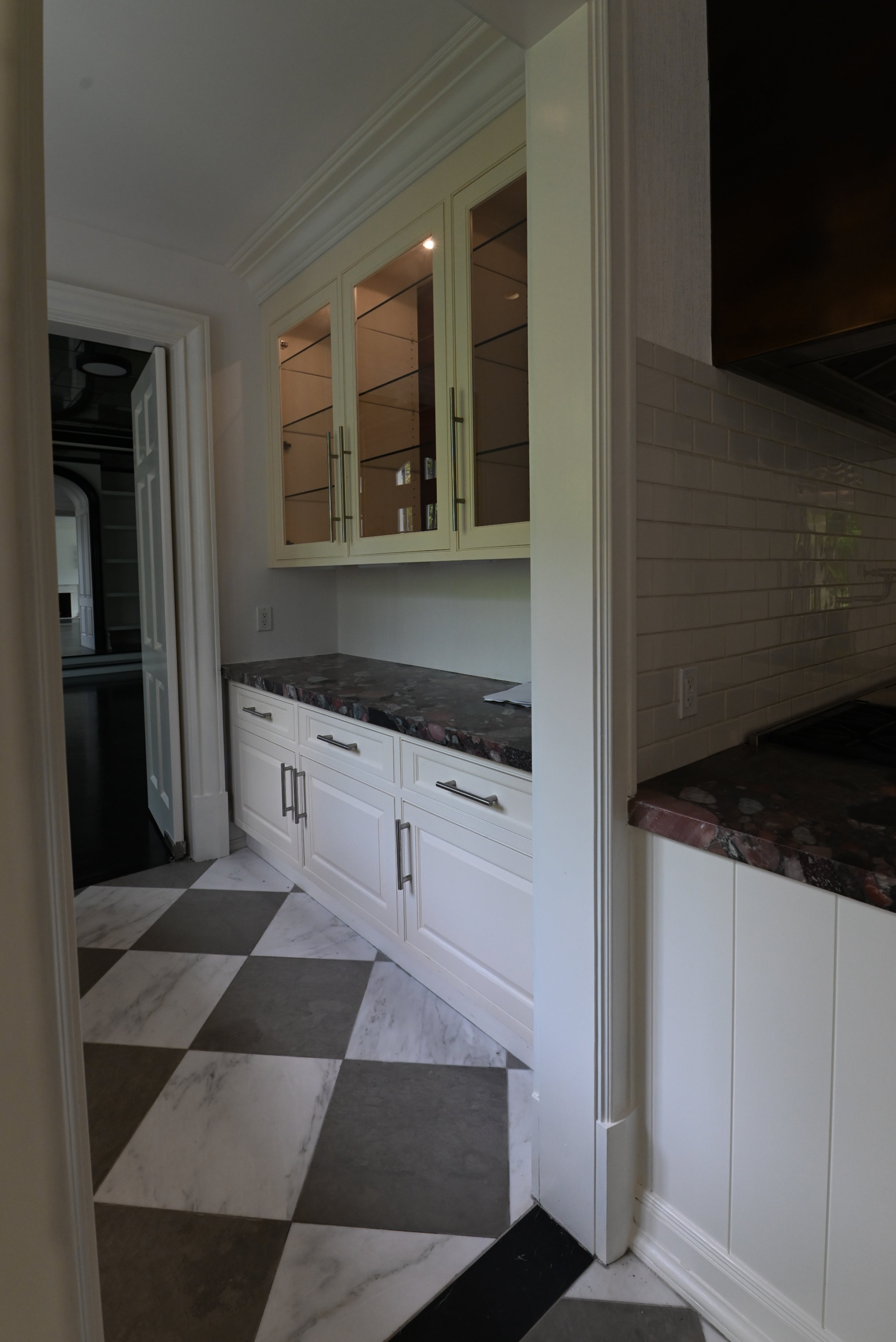 Integrated panel ready dishwasher set within The Dove custom soft white kitchen millwork