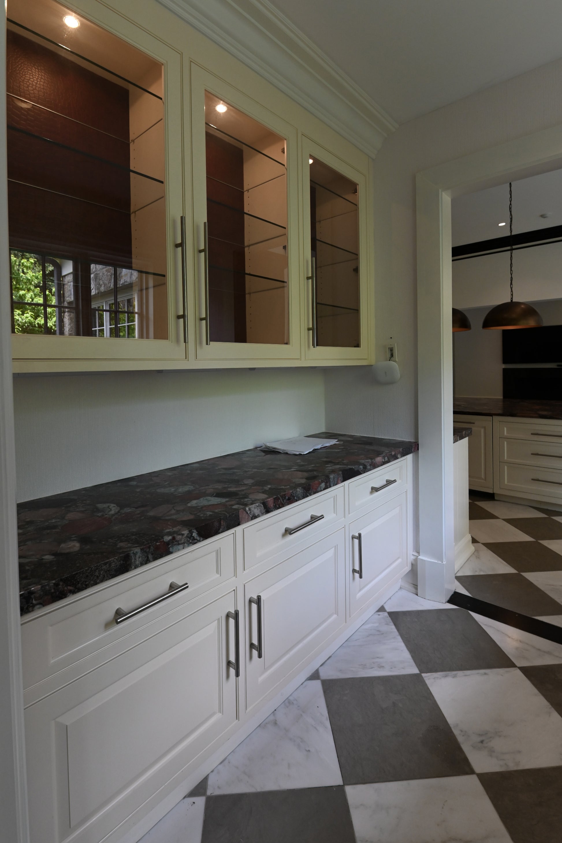 Undercounter clear ice maker installed in a white transitional butler pantry station