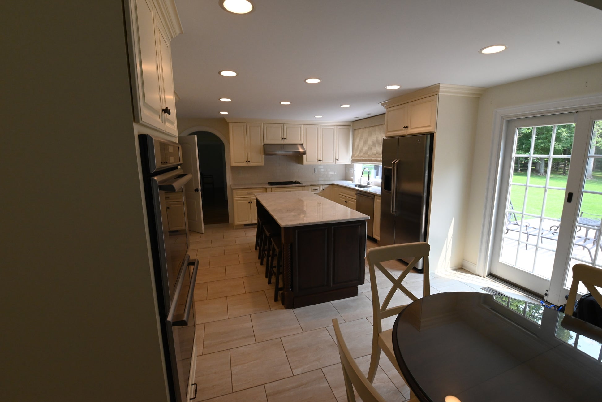 The Windrush traditional light cream kitchen display set featuring raised panel cabinetry, center island, and integrated appliances