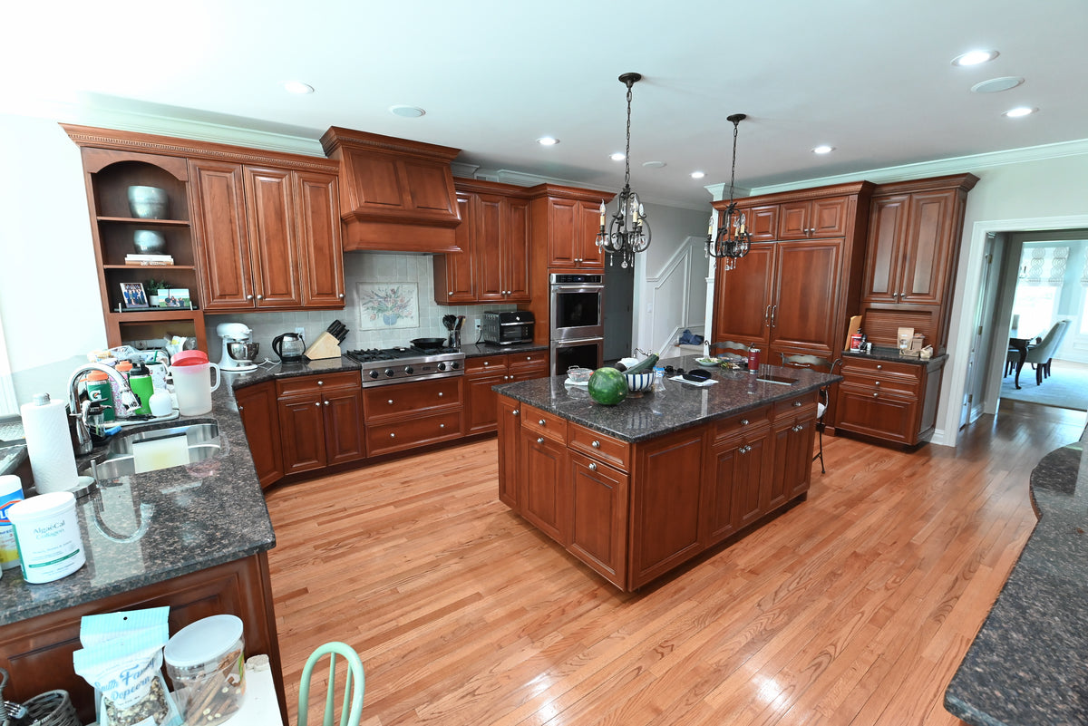 Luxury showroom display natural cherry wood cabinetry and raised panel doors