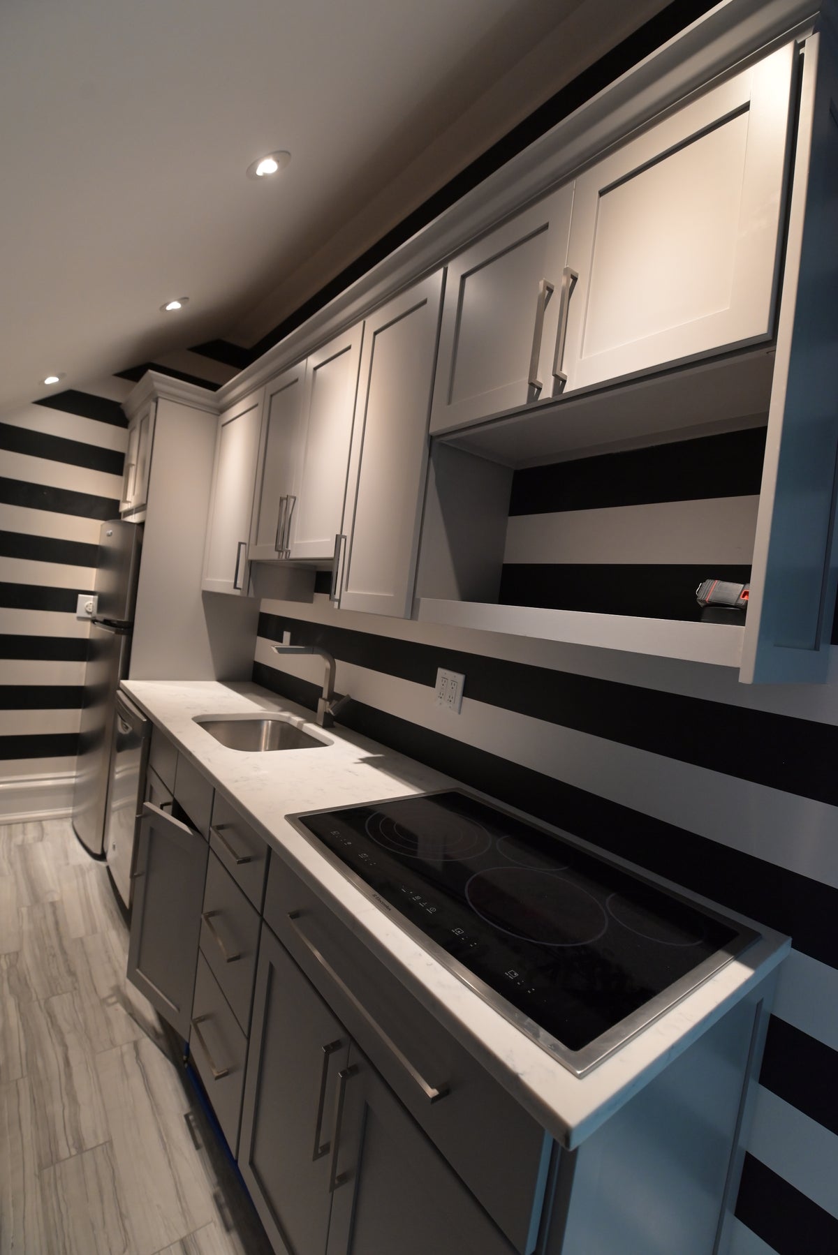 Woodharbor transitional warm gray kitchenette cabinets with integrated appliances