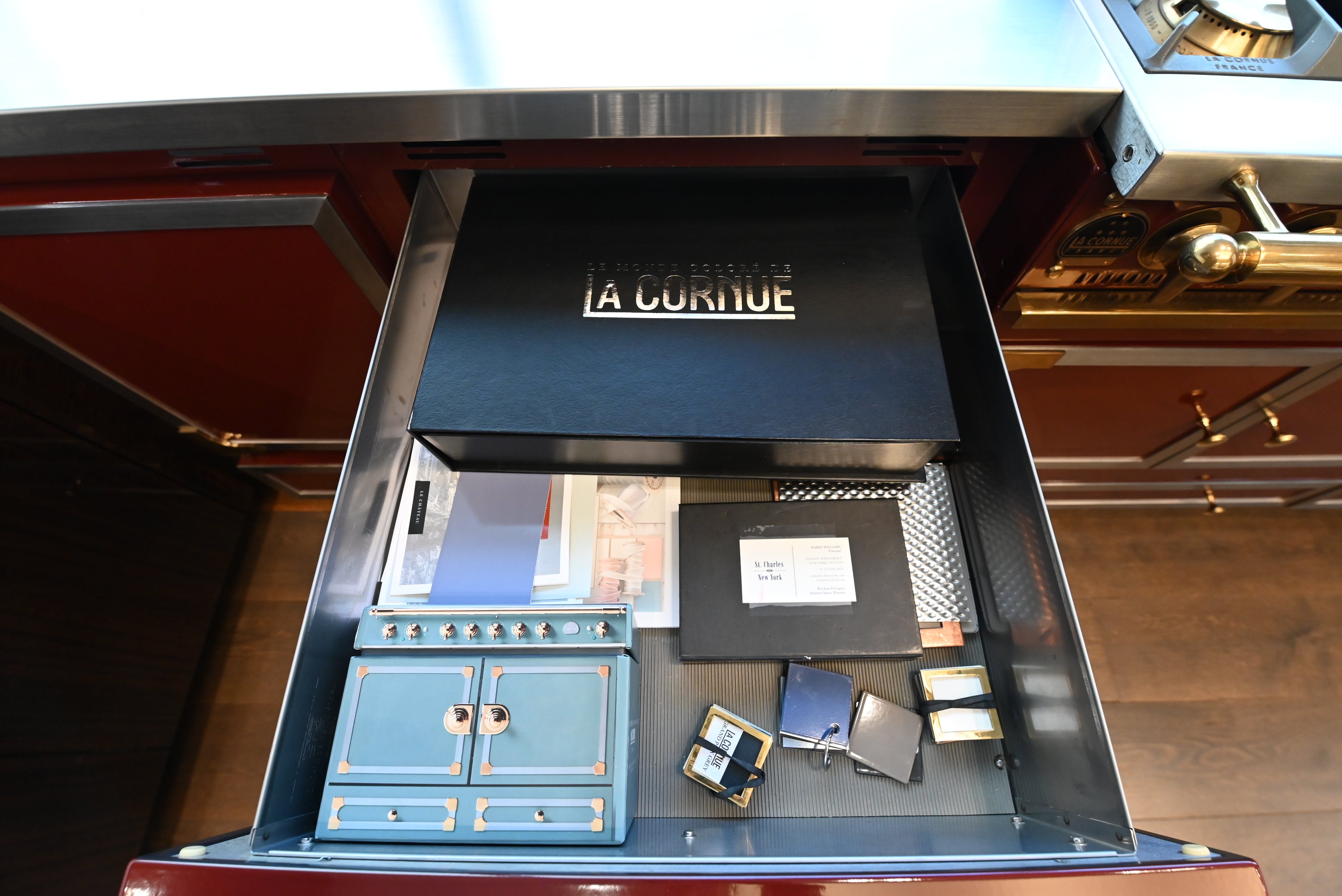 St. Charles Modern Kitchen with La Cornue Chateau Burgundy Cabinets and Glossy Eucalyptus with La Cornue Grand Palais 180 Rangetop and Custom Hood