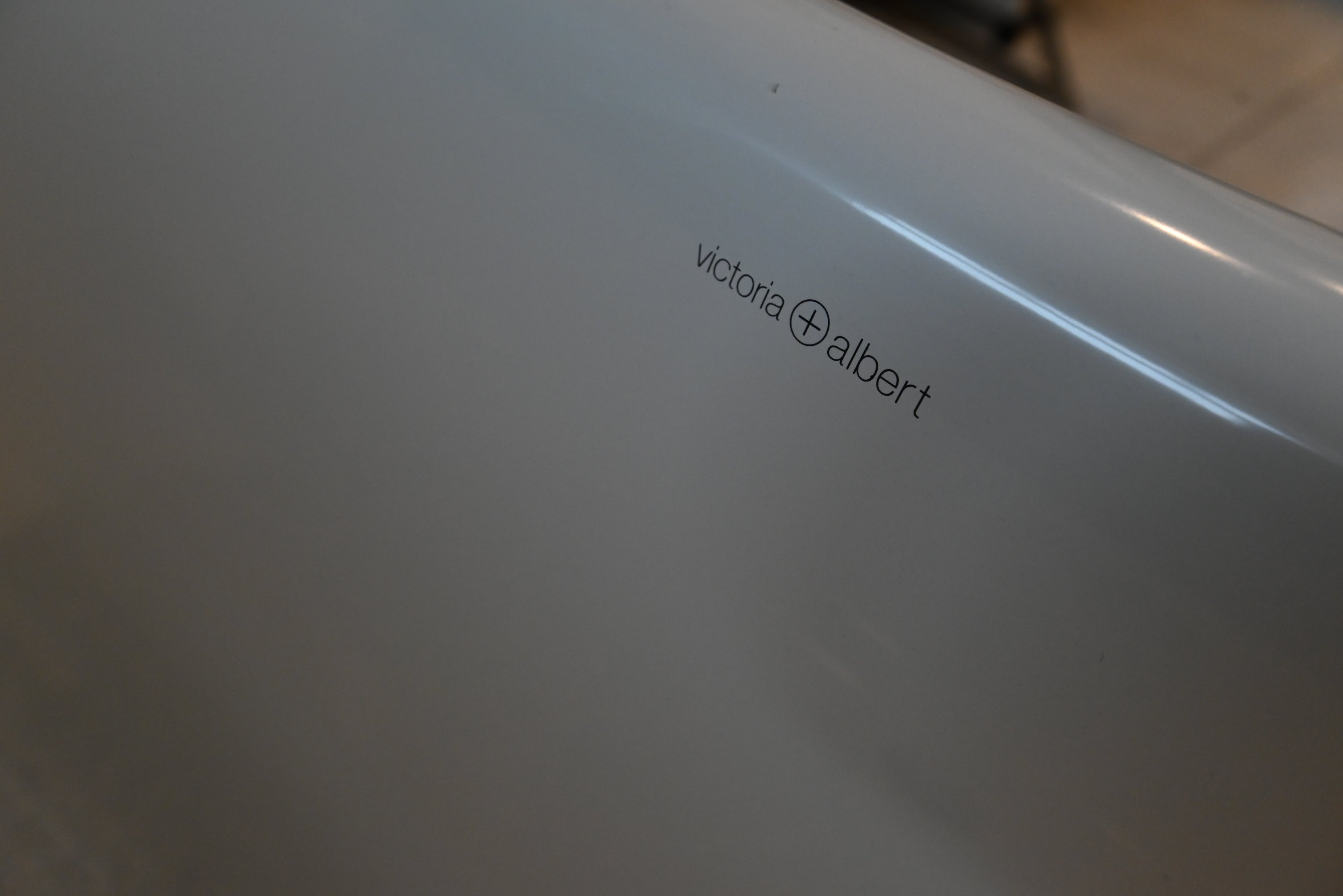 Side view of the Victoria and Albert 74 inch white oval freestanding tub in a modern luxury bathroom