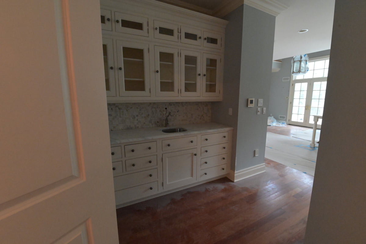High-end architectural residential tall pantry cabinets in classic white finish