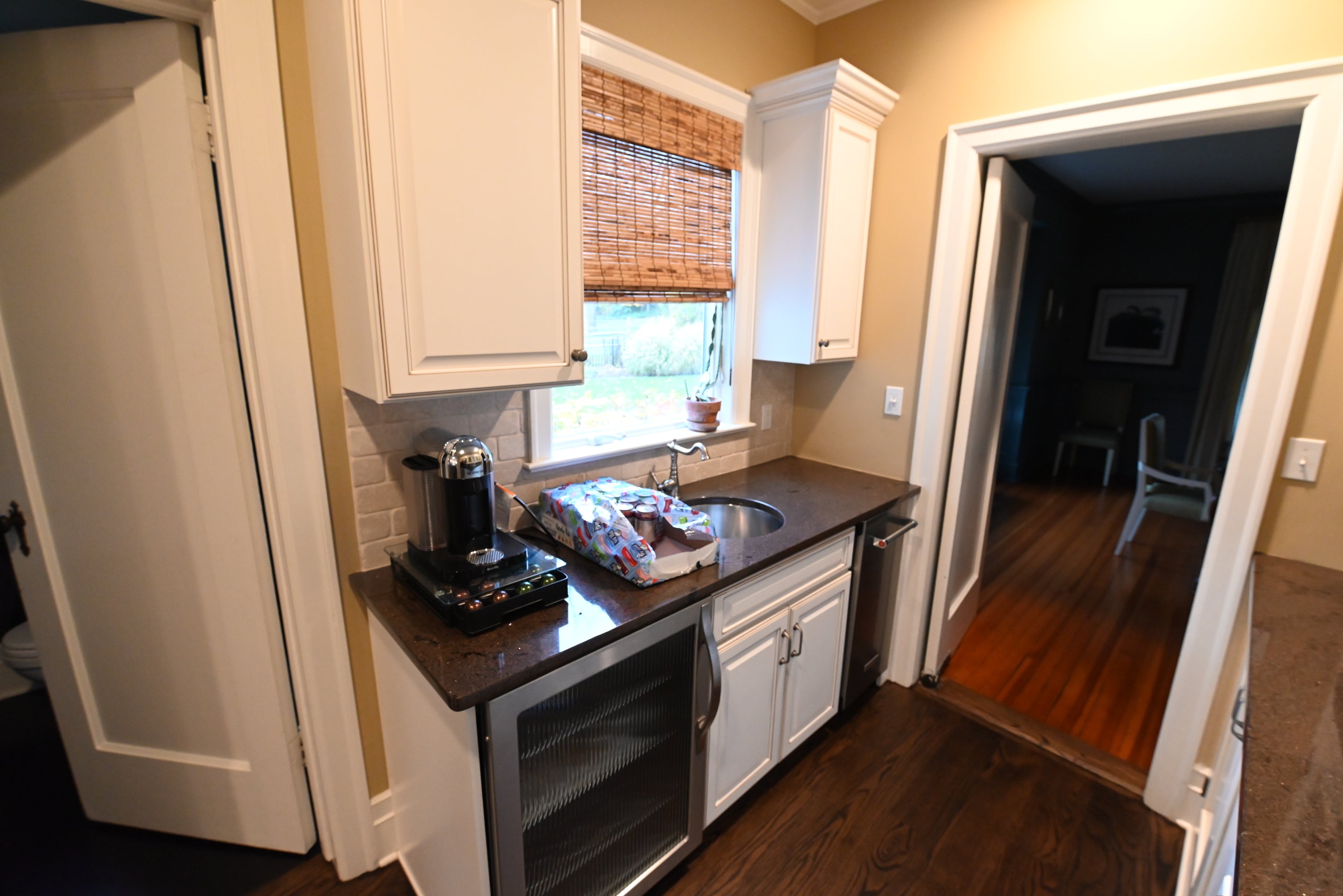 Luxury farmhouse style bar cabinetry with prep sink and traditional faucet