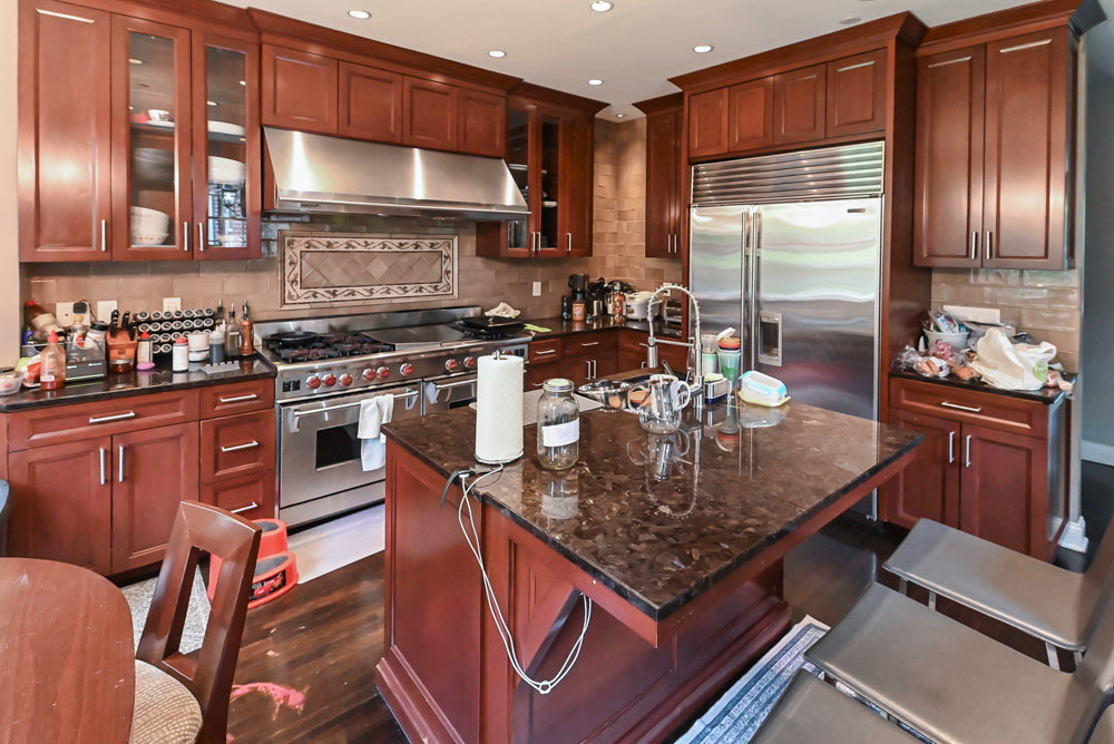 Stylish Dark Wooden Transitional Pre-Owned Kitchen with Appliances and Dark Granite Island