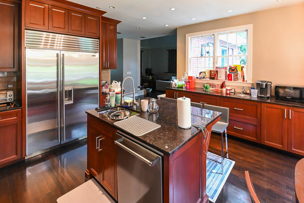 Stylish Dark Wooden Transitional Pre-Owned Kitchen with Appliances and Dark Granite Island