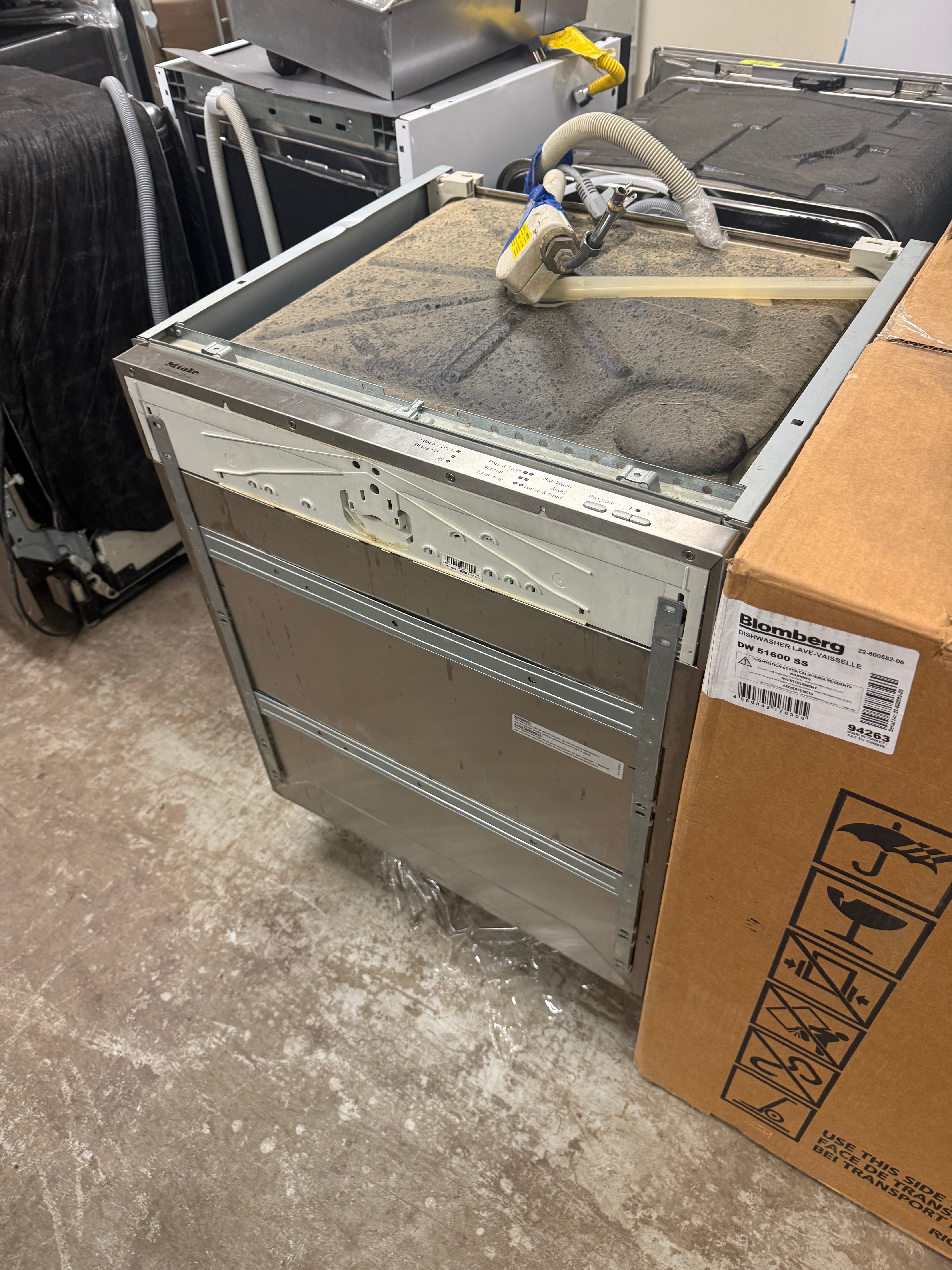 Luxury 24 inch integrated panel dishwasher open showing separate third cutlery tray and stainless steel tub