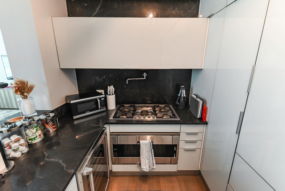 Cesar Modern Glossy White Kitchen with Black Granite Countertops & Appliances