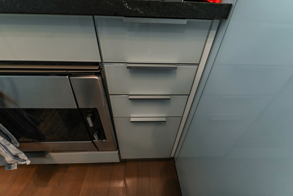 Cesar Modern Glossy White Kitchen with Black Granite Countertops & Appliances