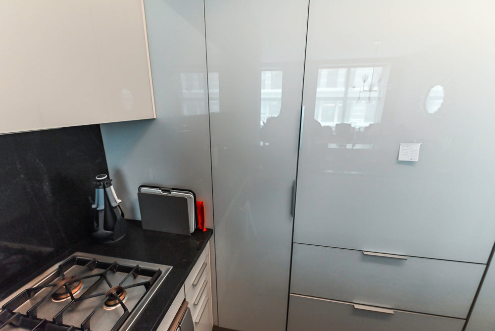 Cesar Modern Glossy White Kitchen with Black Granite Countertops & Appliances