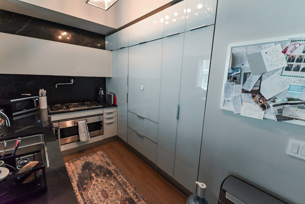 Cesar Modern Glossy White Kitchen with Black Granite Countertops & Appliances