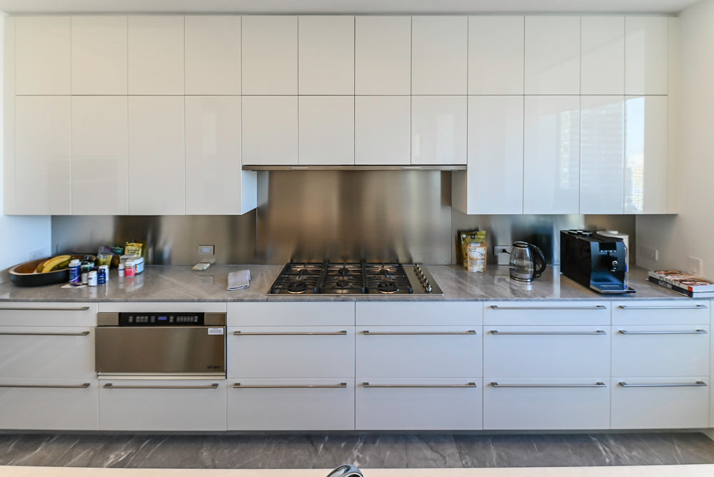 Modern Glossy White Kitchen with Island, Marble Countertops & Miele Appliances