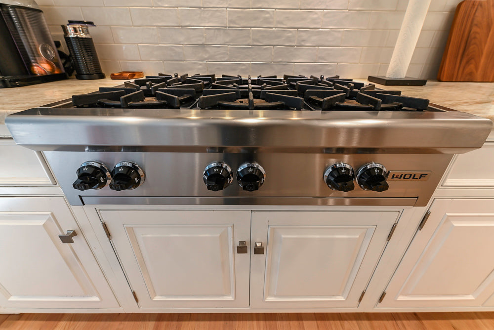 Traditional White Kitchen with Island, Appliances and Marble Countertops