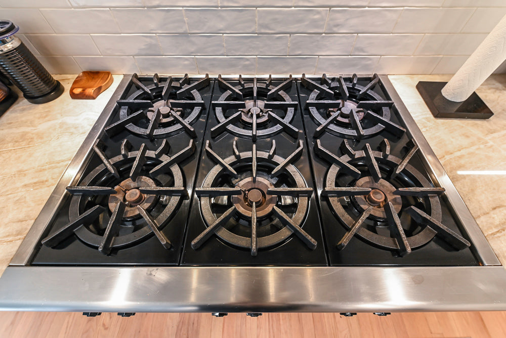 Traditional White Kitchen with Island, Appliances and Marble Countertops