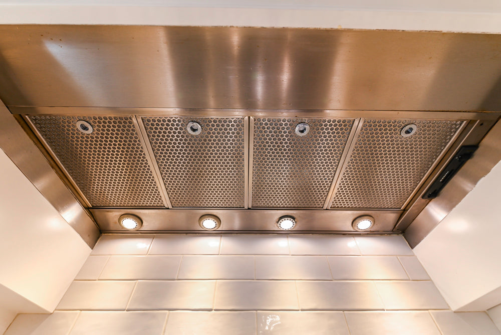 Traditional White Kitchen with Island, Appliances and Marble Countertops