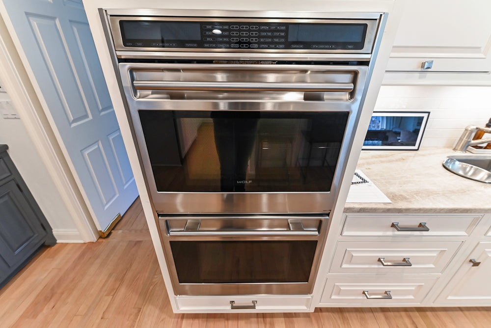 Traditional White Kitchen with Island, Appliances and Marble Countertops