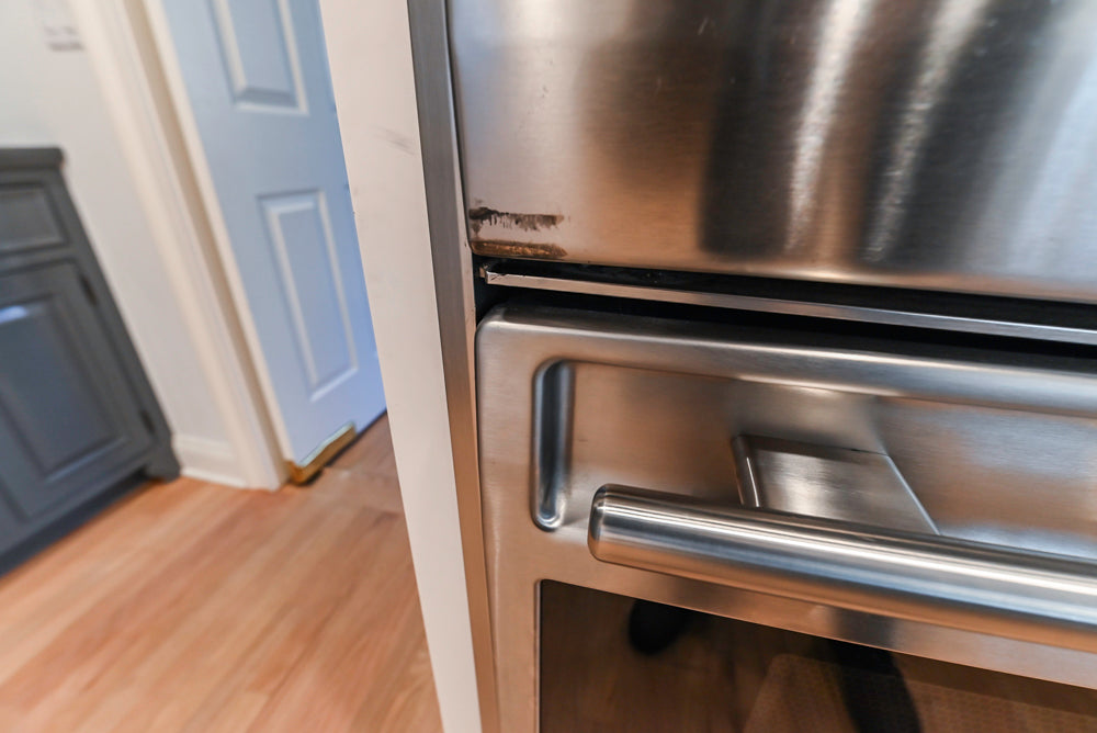 Traditional White Kitchen with Island, Appliances and Marble Countertops