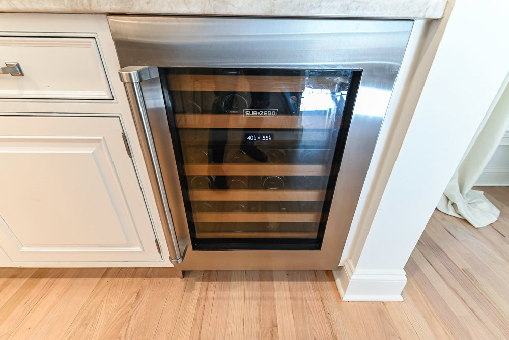Traditional White Kitchen with Island, Appliances and Marble Countertops