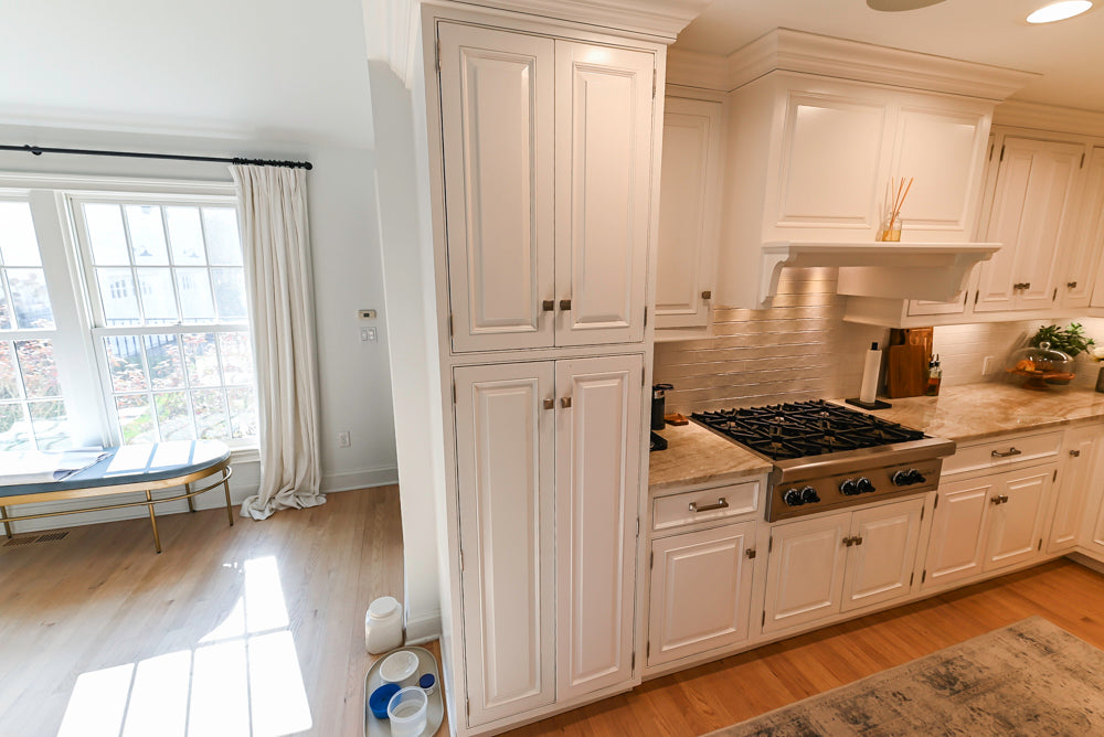 Traditional White Kitchen with Island, Appliances and Marble Countertops