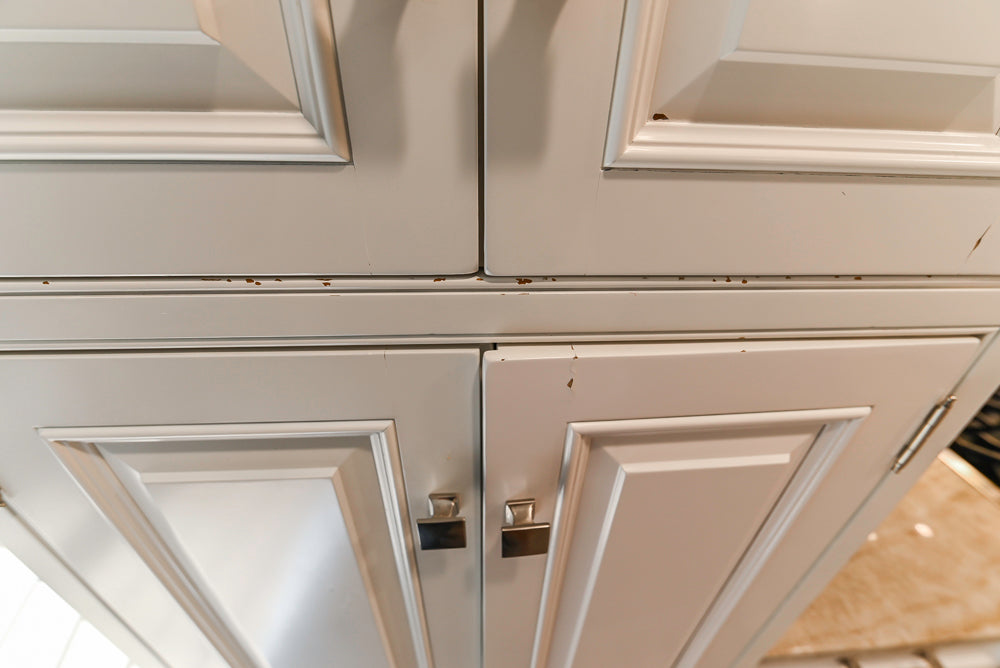 Traditional White Kitchen with Island, Appliances and Marble Countertops