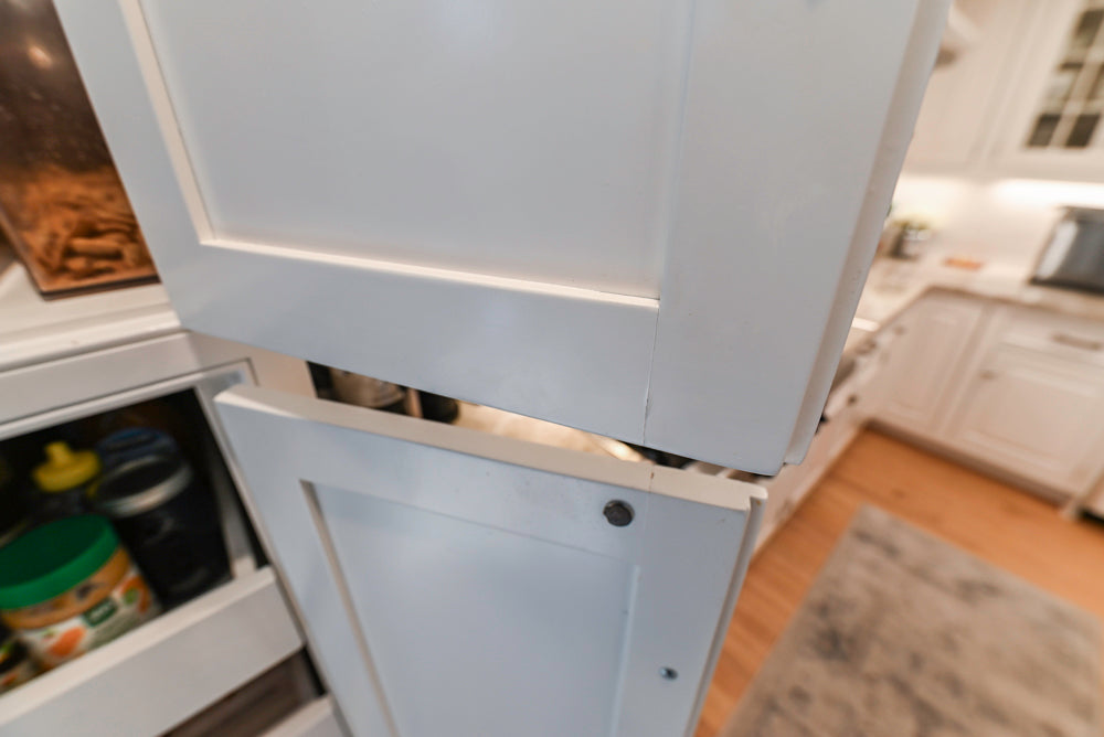 Traditional White Kitchen with Island, Appliances and Marble Countertops